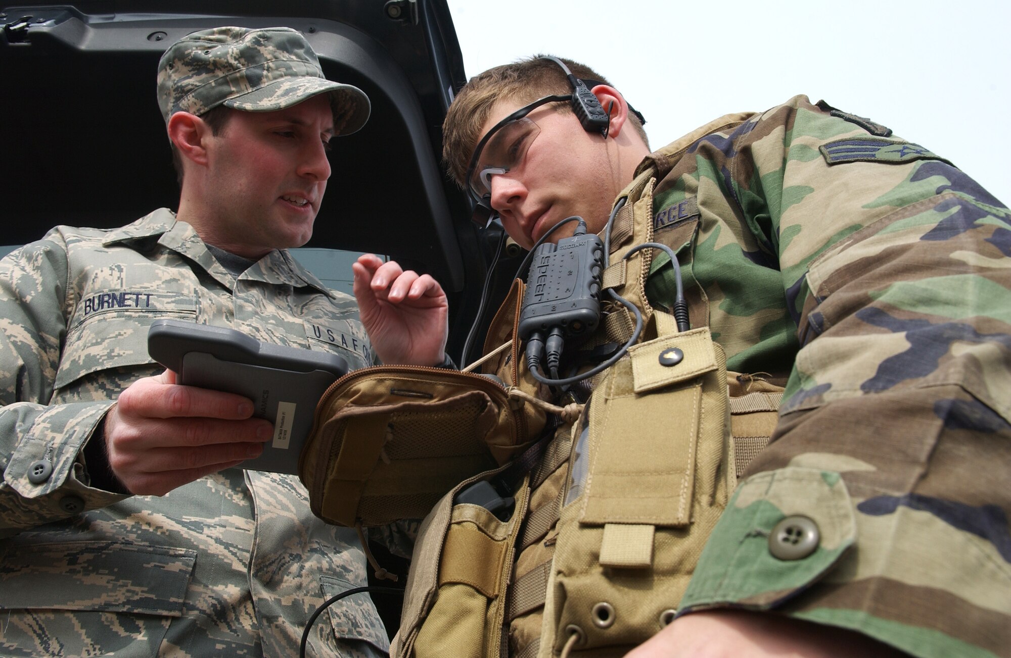 Gregory Burnett explains to Senior Airman Nicholas Halladay the capabilities of a MR-1 computer that can send global positioning satellite coordinates to an aircraft May 5, 2008, at Eielson Air Force Base, Alaska during Northern Edge 08 exercise. Tactical Air Control Party Airmen are helping test new experimental equipment in the field. After several tests, they are providing feedback on how the equipment worked if any improvements could be made before the equipment will be used in combat situations years from now. Northern Edge is a joint training exercise hosted by Alaskan Command and is one of a series of U.S. Pacific Command exercises that prepare joint forces to respond to crises in the Asian Pacific region. Airman Halladay is a TACP assigned to Detachment 1, 3rd Air Support Operation Squadron from Fort Richardson, Alaska. Mr. Burnett is an Air Force Civilian from Wright-Patterson Air Force Base. (U.S. Air Force Photo/Airman 1st Class Jonathan Snyder)
