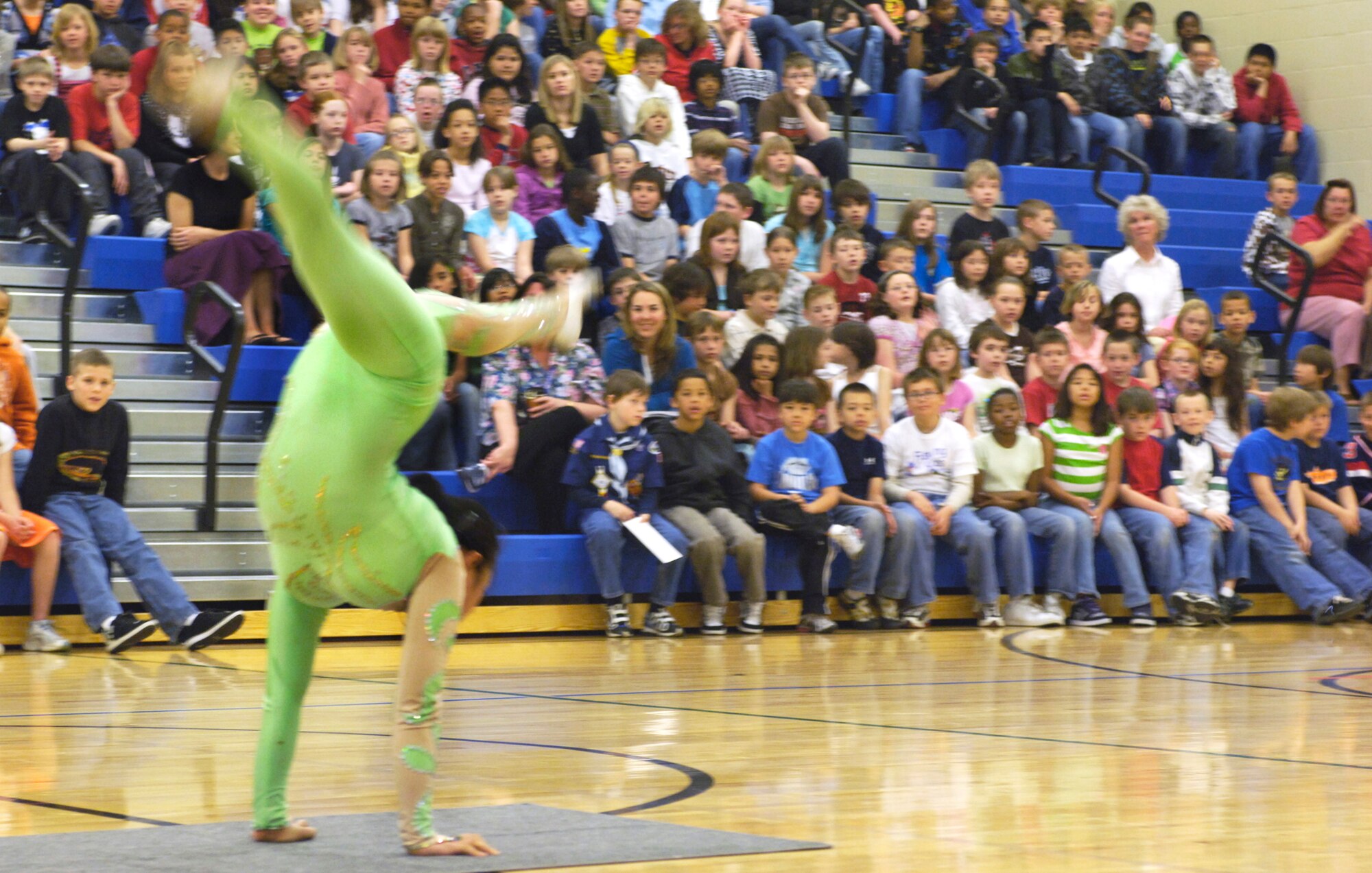 FAIRCHILD AIR FORCE BASE, Wash. – Chinese acrobat Lili Wu travels across the Michael Anderson Elementary school gym while masterfully performing acrobatics here May 13. The students at Michael Anderson were visited by a group of Chinese acrobats in celebration of their achievements in the school recycling contest. (U.S. Air Force photo / Airman 1st Class Melissa Barnett)