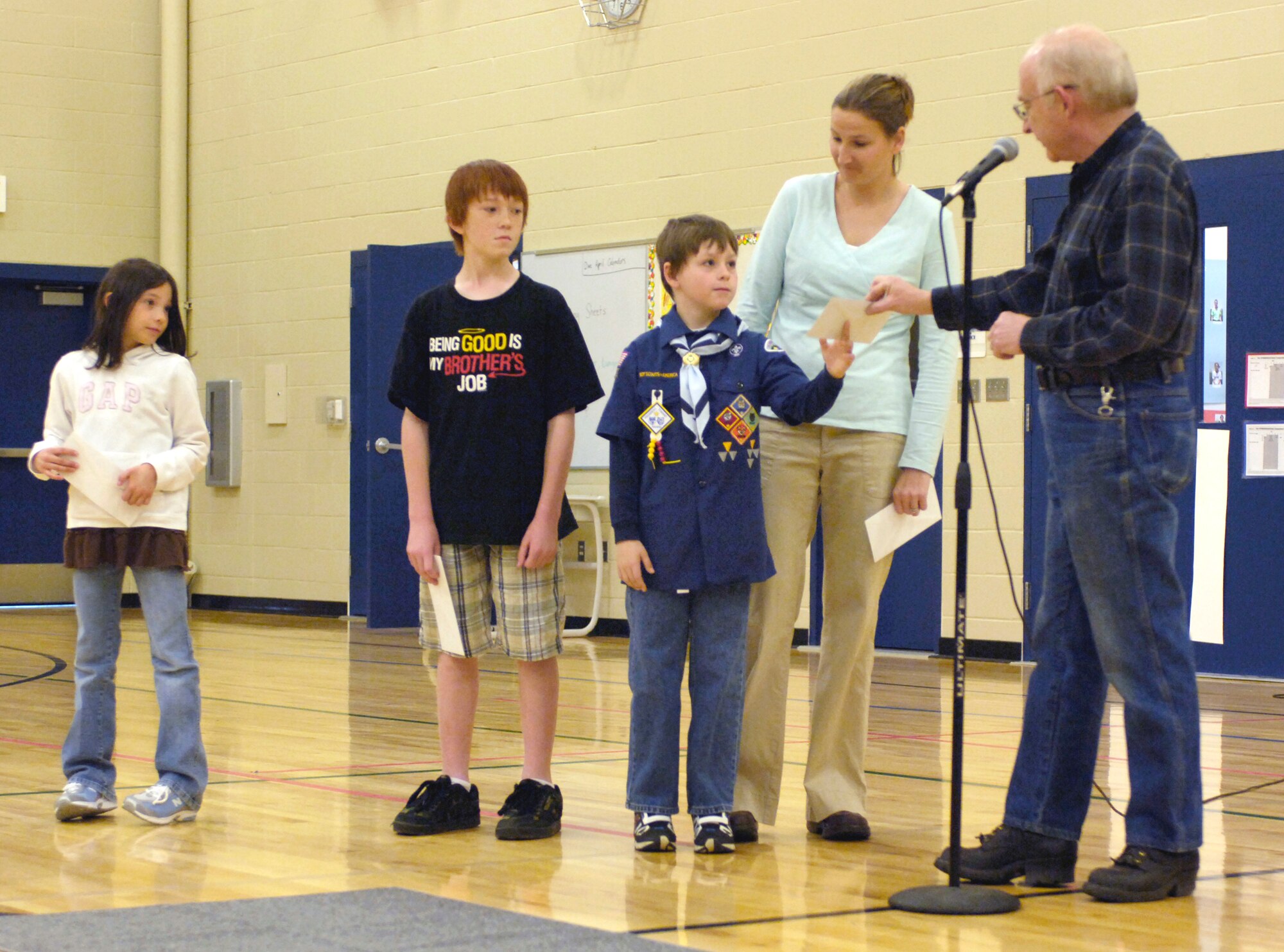 FAIRCHILD AIR FORCE BASE, Wash. – Michael Anderson Elementary school students Ryan Allen, 3rd grade, Victoria Phelan, 3rd grade, and Addison Hoggan, 5th grade, receive prizes for their outstanding effort in the recycling contest here May 13.  (U.S. Air Force photo / Airman 1st Class Melissa Barnett)