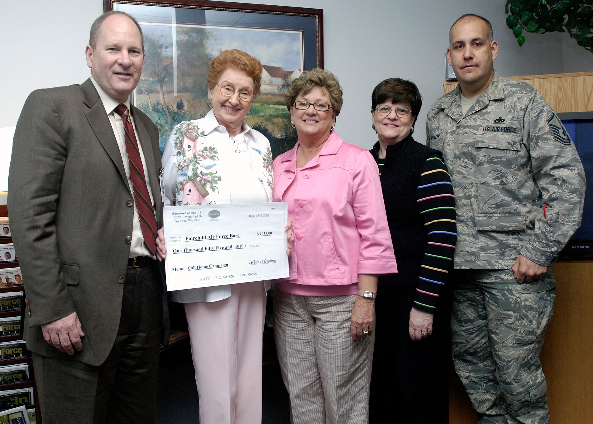 FAIRCHILD AIR FORCE BASE, Wash. – Members of the Waterford community present Linda Miles, Airman & Family Readiness Center, and Master Sgt. Scott Woller, 92nd Mission Support Squadron, with a check for $1,055 here May 8. The money is a donation toward the Call Home Campaign, and will be used to help purchase calling cards for deployed military members. (U.S. Air Force photo / Senior Airman Eunique Stevens)