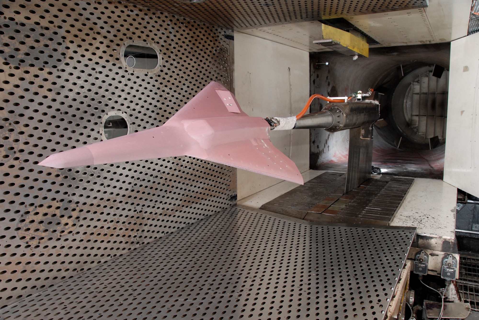 A one-eighteenth scale model of an Air Force tailless aircraft recently underwent aerodynamic testing in Arnold Engineering Development Center’s four-foot transonic wind tunnel. The test was a technology demonstration entry in which conventional methods and Pressure Sensitive Paint were used to compare the effectiveness of a jet effects spoiler with a solid spoiler in yaw and roll control and stability of the aircraft. (Photos by Rick Goodfriend)