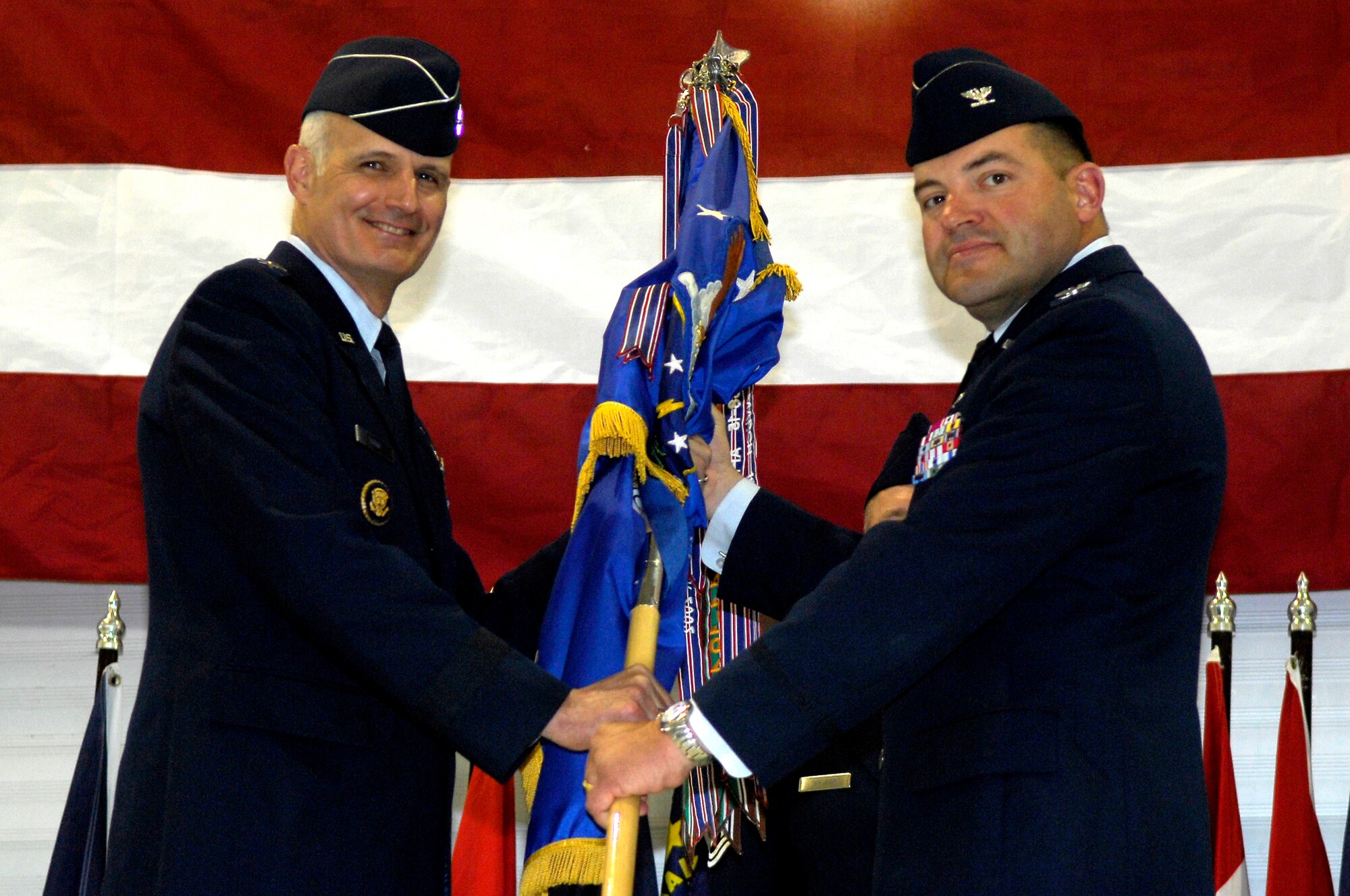 MINOT AIR FORCE BASE, N.D. – Maj. Gen. Roger W. Burg, 20th Air Force commander (left), turns over command of the 91st Space Wing to Col. Christopher B. Ayres during a change of command ceremony here May 13. Colonel Ayres assumed command of the wing from Col. Marty Whelan, who has been assigned to U.S. Strategic Command at Offutt Air Force Base, Neb. (U.S. Air Force photo by Senior Airman Joe Rivera)