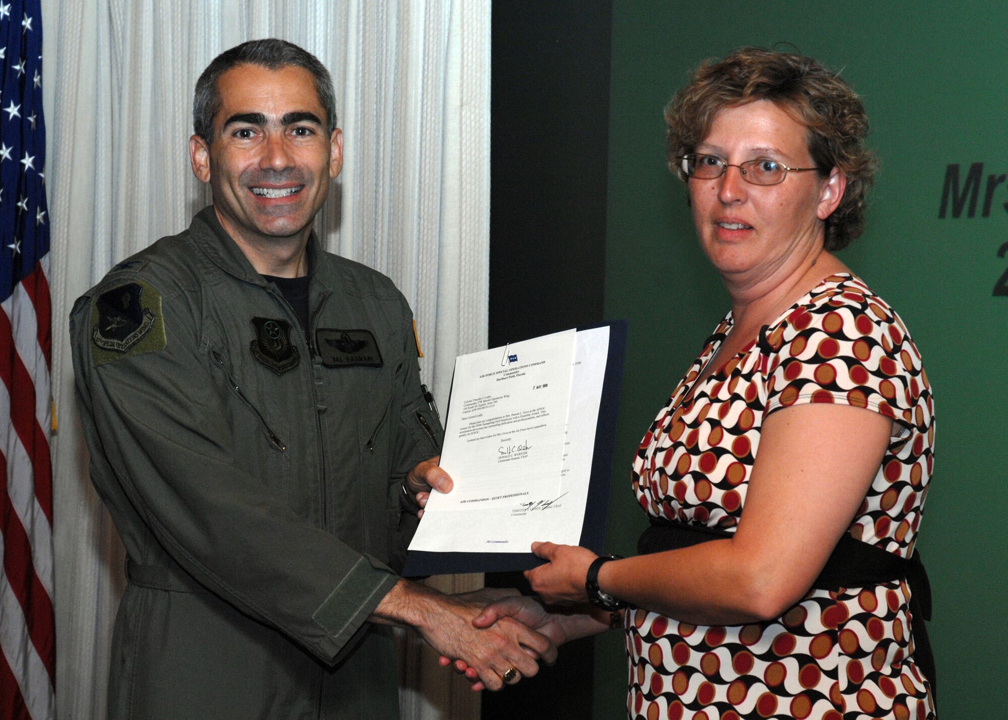 CANNON AIR FORCE BASE, N.M. --  Pam Gove, 27th Special Operations Maintenance Support Squadron, receives the Outstanding Department of Defense Employee With A Disability Award presented by Col. Valentino Bagnani III, 27th Special Operation Wing vice commander. Mrs. Gove received the award at the weekly wing staff meeting on May 13. (U.S. Air Force photo by Airman 1st Class Danielle Martin)