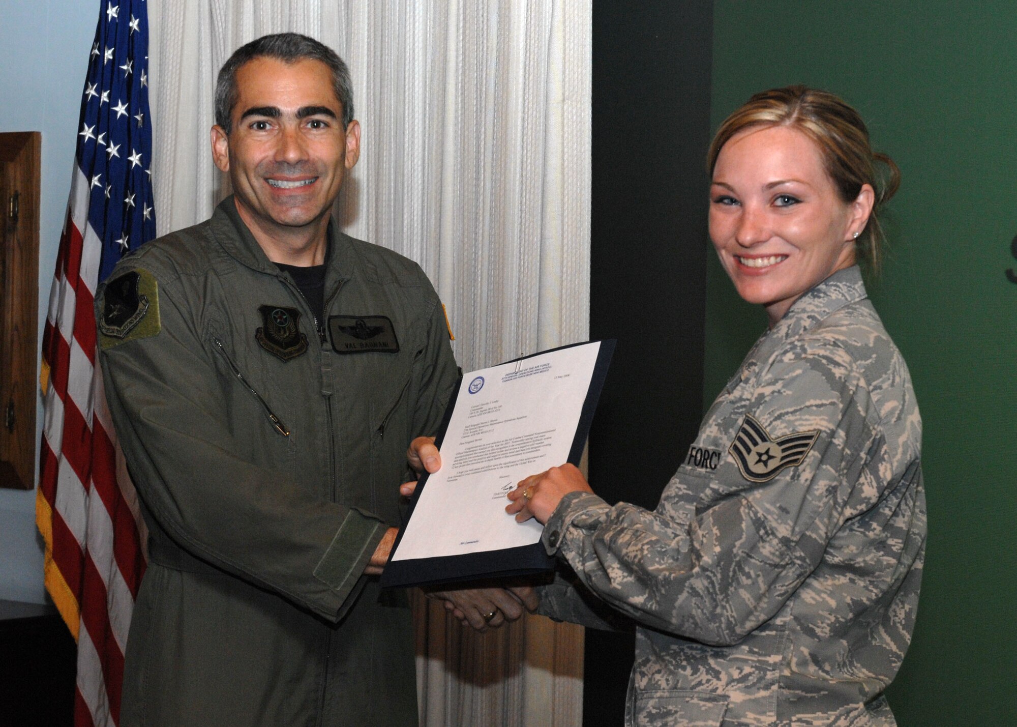 CANNON AIR FORCE BASE, N.M.-- Staff Sgt Naomi Brown, 27th Special Operations Maintenance Operations Squadron, receives the Maintenance Analyst/Section of the Year award presented by Col. Valentino Bagnani III, 27th Special Operation Wing vice commander. Sergeant Brown received the award at the weekly wing staff meeting on May 13. (U.S. Air Force photo by Airman 1st Class Danielle Martin)