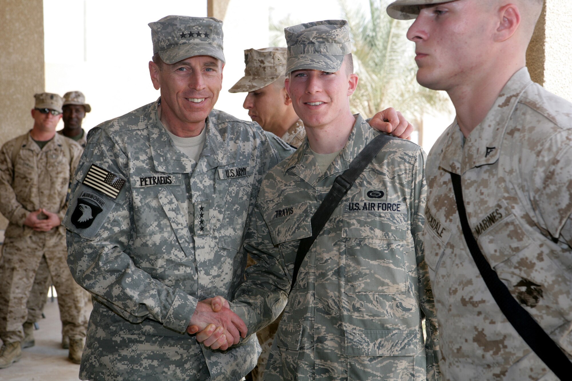 General David Patraeus, Commanding General, Multi National Force - Iraq, stands with Airman 1st Class Broch Travis on Camp Fallujah, Iraq on April 23. General Patraeus visited with a group of military members prior to departing Camp Fallujah.  (U.S. Marine Corps photo by Cpl. Erin A. Kirk)