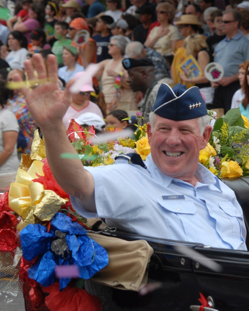 Gen. William Looney, Commander of Air Education and Training Command, waves to spectators at the Battle of Flowers parade in San Antonio April 25. General Looney was the Fiesta 2008 military coordinator. (U.S. Air Force photo by Rich McFadden)