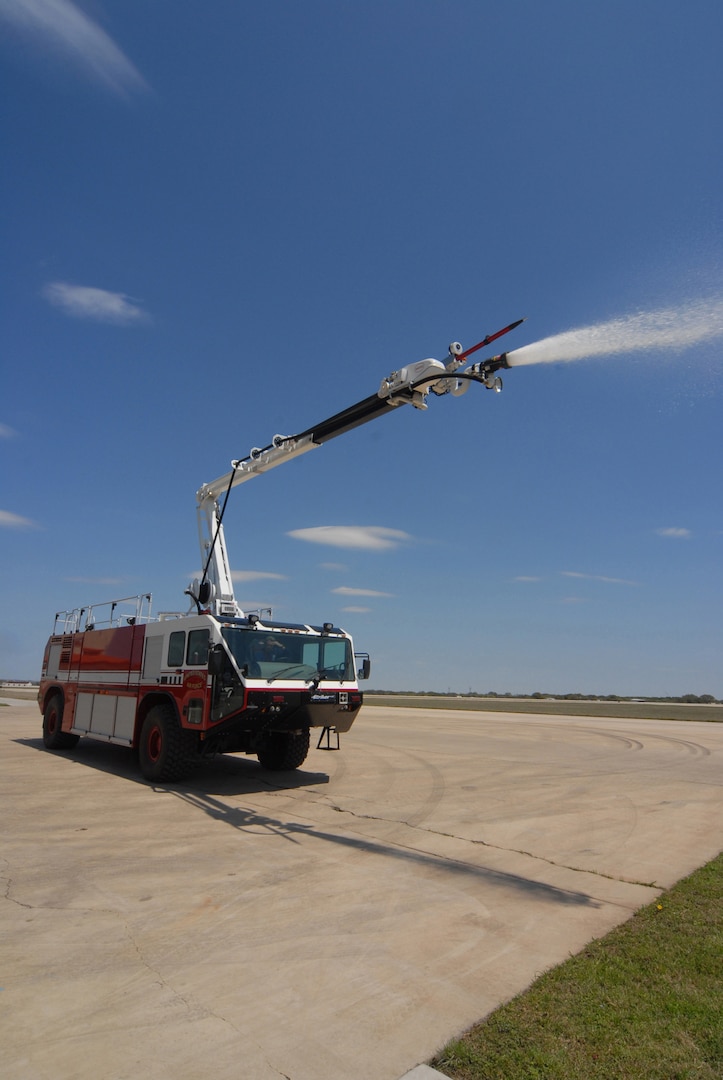 12th Civil Engineer Division Fire and Emergency Services personnel demonstrate the boom turret capability of their new Oshkosh Striker aircraft rescue fire fighting vehicle April 24. (U.S. Air Force photo by Steve White)