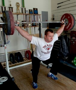 LANGLEY AIR FORCE BASE, Va. -- Staff Sgt. Norman Fulk executes a "Snatch" lift in preparation for the Olympic Trials in Atlanta, May 16 and 17. Previously assigned to the 83rd Communications Squadron, Sergeant Fulk is now assigned to the Air Force World Class Athlete Program, a two-year program that allows him to train for the Olympics. (U.S. Air Force photo/Tech. Sgt. Levi Collins)