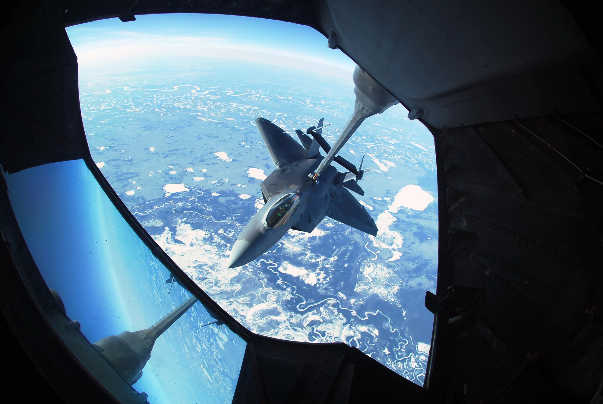 An F-22 Raptor refuels behind a KC-10 Extender April 17 while at 26,000 feet above Eielson Air Force Base, Alaska. The F-22 is assigned to Elmendorf Air Force Base, Alaska. (U.S. Air Force Photo/Airman 1st Class Jonathan Snyder) 