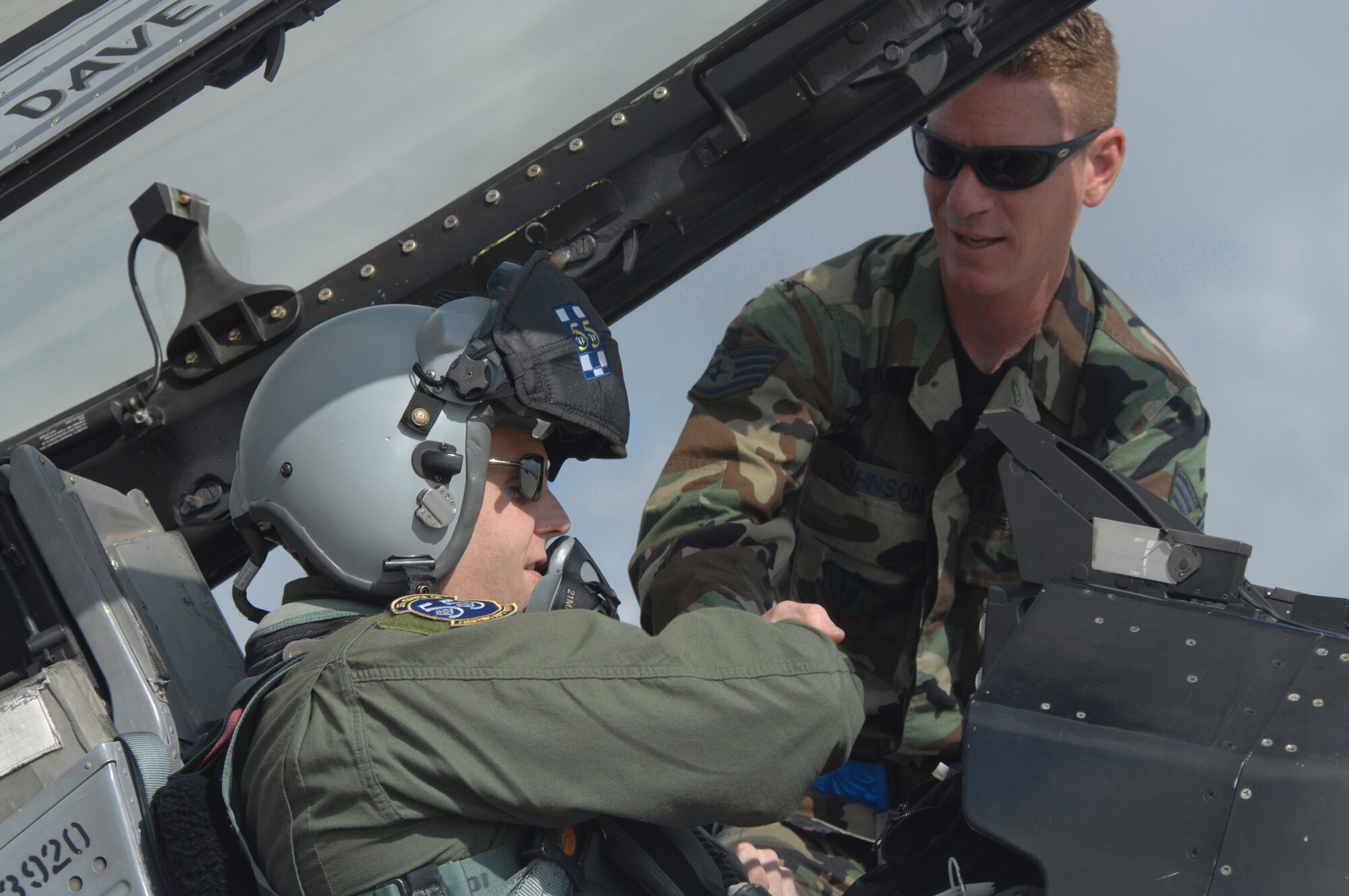 SHAW AIR FORCE BASE, S.C. -- Lt. Col. Miles "Quatro" Demayo, 55th Fighter Squadron commander, shakes hands with Staff Sgt. Brett Johnson, 55th Fighter Squadron crew chief, before closing the canopy of the F-16 May 9. The 55th Fighter Squadron and 20th Aircraft Maintenance Unit are deploying 16 jets and 172 Airmen to Hill AFB, Utah, for Operation Combat Hammer. Combat Hammer is an exercise evaluation that allows the squadron to be operationally assessed on the effectiveness and suitability of weapons and weapons systems in several different tactical scenarios. (U.S. Air Force photo/Staff Sgt. Nathan Bevier)