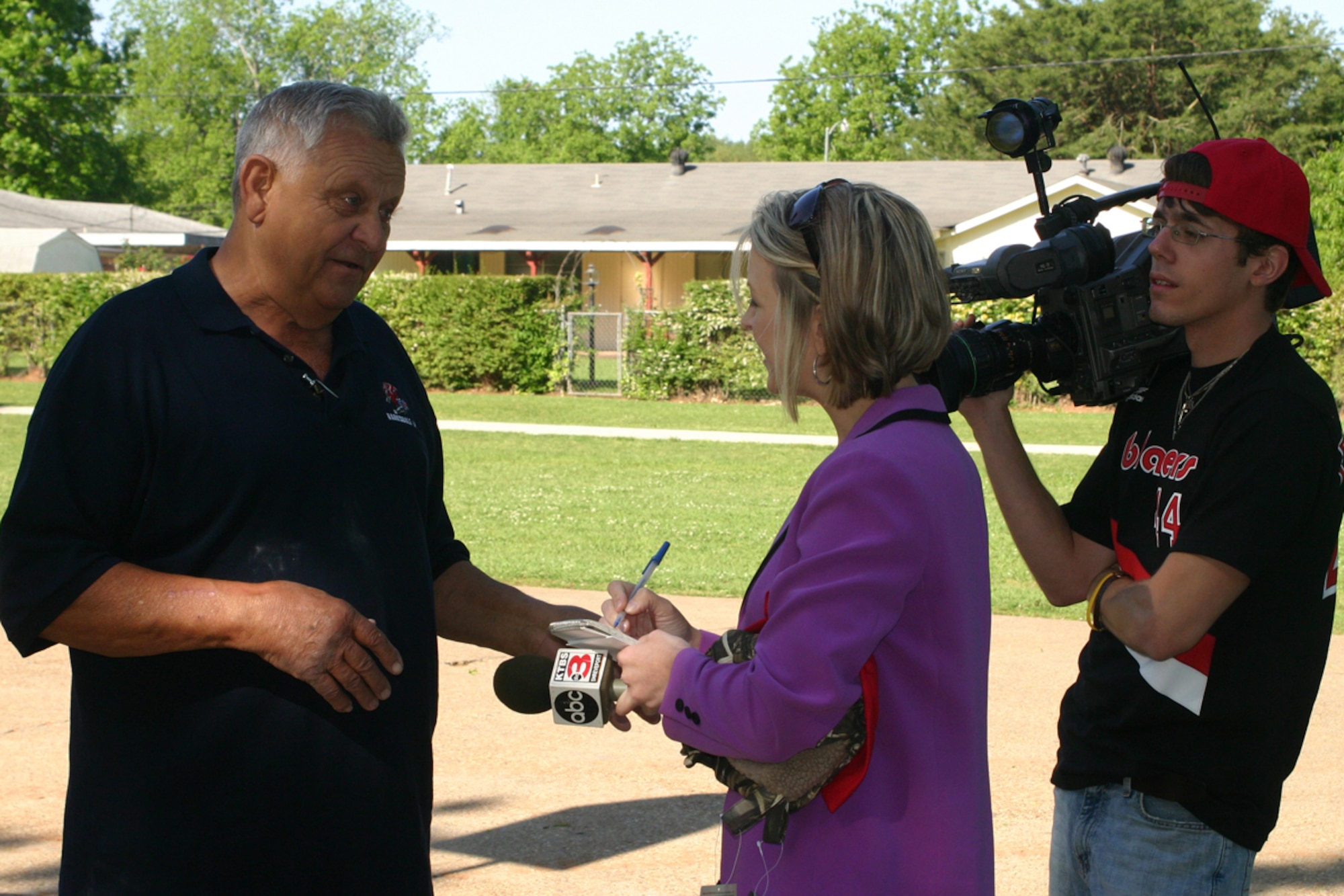 KTBS, Channel 3 reporter, Chrissi Coile from Shreveport, and Cameraman Chris Arnold, interview Curley Huddleston at the welcome home picnic for the 307th Red Horse Squadron and 360th Chemical Army Guard Unit at Mike Woods Park in Bossier City, LA, Saturday, May 3, 2008. The event was arranged in part by Huddleston and VFW Post 5951 for members of both units who recently returned from service in Iraq. (U.S. Air Force photo/Tech. Sgt. Jeffrey S. Walston)