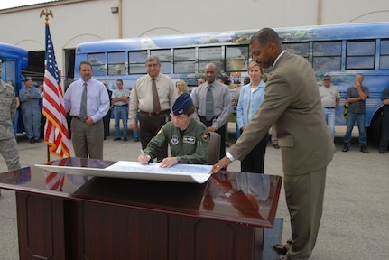 Col. Jacqueline Van Ovost, 12th Flying Training Wing commander, signs the National Transportation Week proclamation Wednesday. (U.S. Air Force photo by Rich McFadden)
