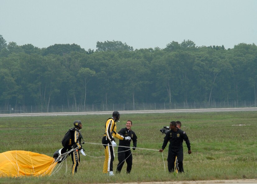 BARKSDALE AFB , La.—Karl “The Mailman” Malone lands on the flight line here after a tandem sky dive with the U.S. Army Golden Knights Parachute Demonstration Team during the Defenders of Liberty Air Show on May 11.   The air show commemorates the 75th anniversary of Barksdale Air Force Base. (U.S. Air Force photo by Airman 1st Class Brittany Bateman)