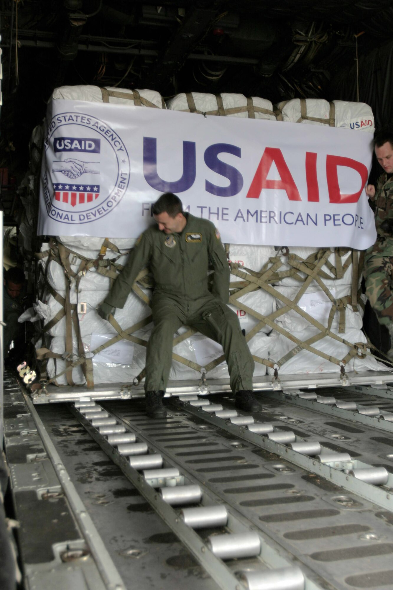 Senior Airman Daniel Mortensen secures a pallet of supplies in a C-130 Hercules May 12 at Utapao Air Base, Thailand. The aircraft flew to Burma as part of Joint Task Force Caring Response, the joint humanitarian assistance and disaster relief response to Tropical Cyclone Nagris. Airman Mortensen is a a loadmaster with the 36th Airlift Squadron from Yokota Air Base, Japan. (U.S. Marine photo/Lance Cpl. Robert A. Harding) 
