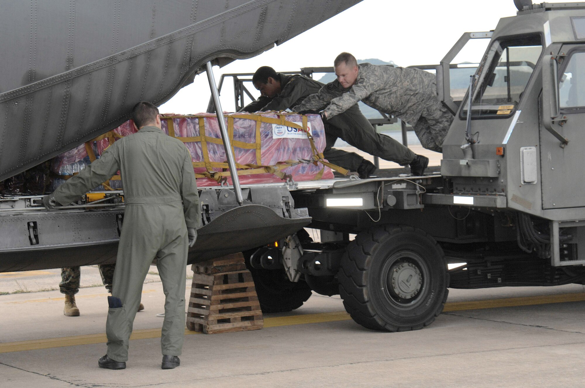 Master Sgt. Todd Kneisly and Airman 1st Class Robert Gore load a C-130 Hercules with humanitarian relief supplies for victims of Burma May 12 at Utapao Air Base, Thailand. The relief supplies are for those who were struck by Cyclone Nargis May 2. As of May 12, a total of $3,250,000 in USAID, and humanitarian assistances has been provided to Burma. Sergeant Kneisly is assigned to the 36th Mission Response Squadron from Andersen Air Force Base, Guam, and Airman Gore is assigned to the 36th Airlift Squadron, Yokota Air Base, Japan, (U.S. Air Force photo/Senior Airman Sonya Croston) 
