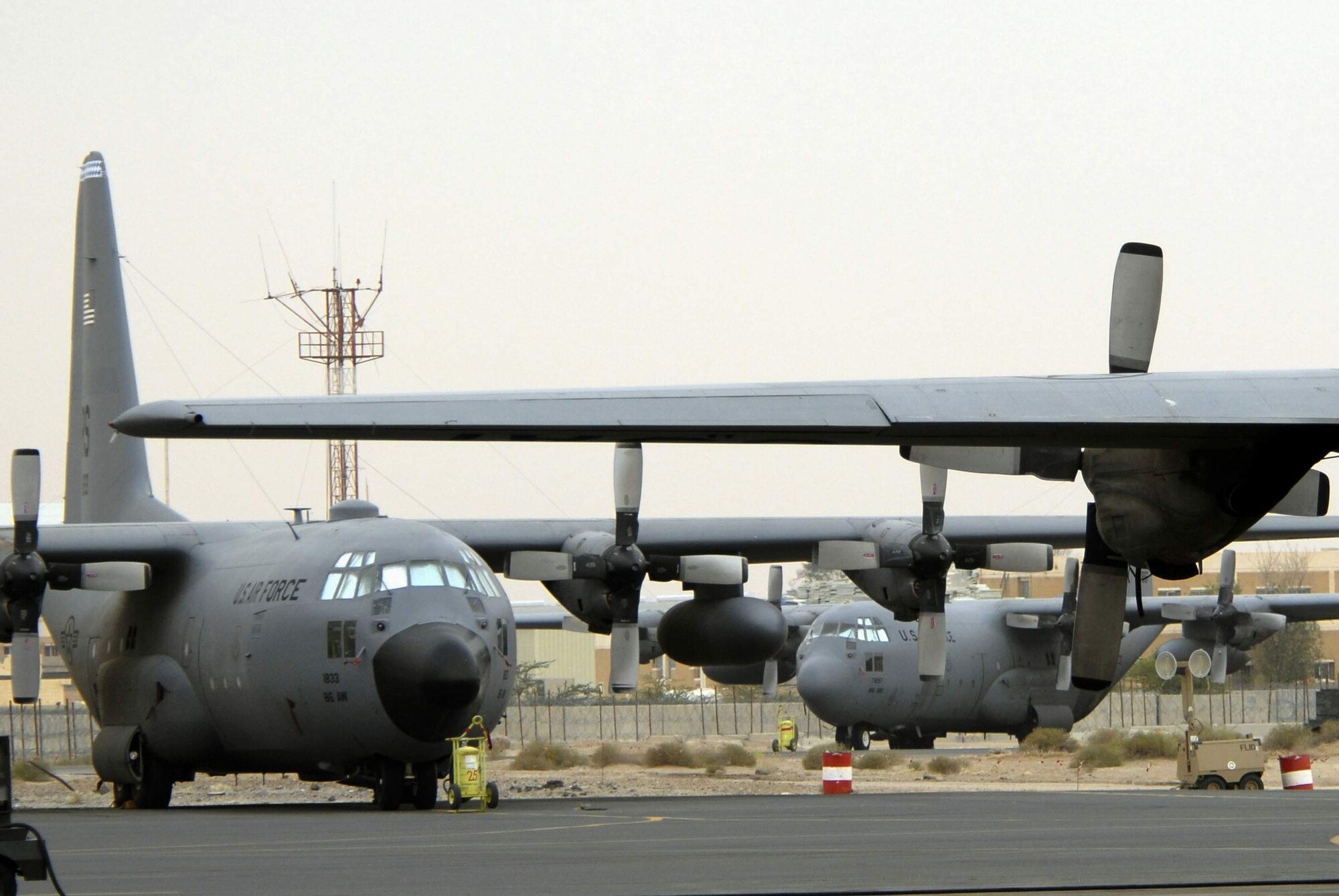 C-130 Hercules aircraft wait for an airlift mission April 17 at an air base in Southwest Asia. These C-130s transport coalition forces and equipment throughout the area of responsibility in support of operations Enduring Freedom and Iraqi Freedom (U.S. Air Force photo/Staff Sgt. Patrick Dixon)
