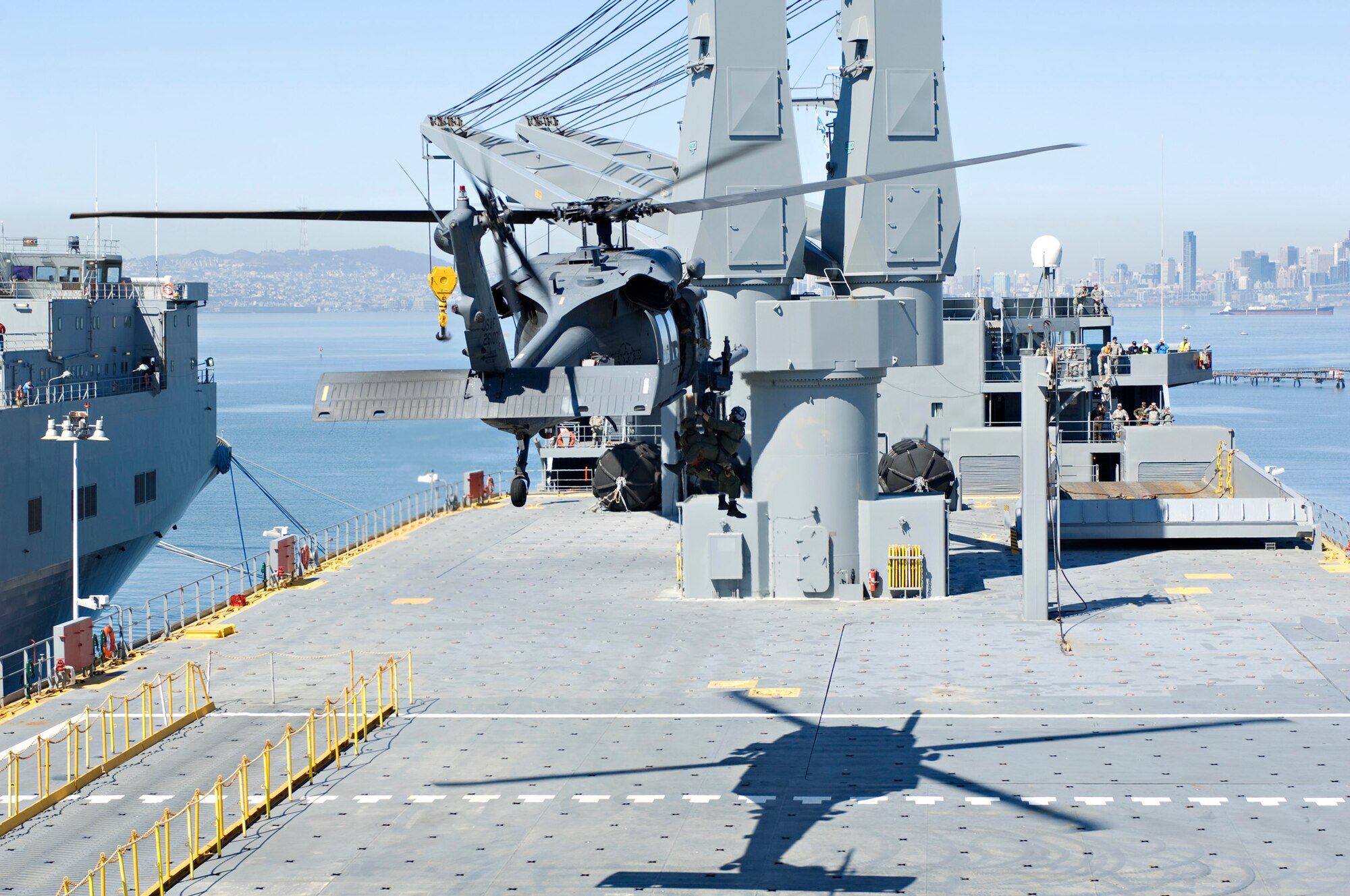 An HH-60G Pave Hawk from the 129th Rescue Wing hovers over the USNS Algol as it hoists down pararescueman Tech. Sgt. Michael Bendle and a federal agent during a full-scale local exercise at Alameda Point, Calif. April 17. (U.S. Army photo by CW3 Jon-Nolan Paresa)