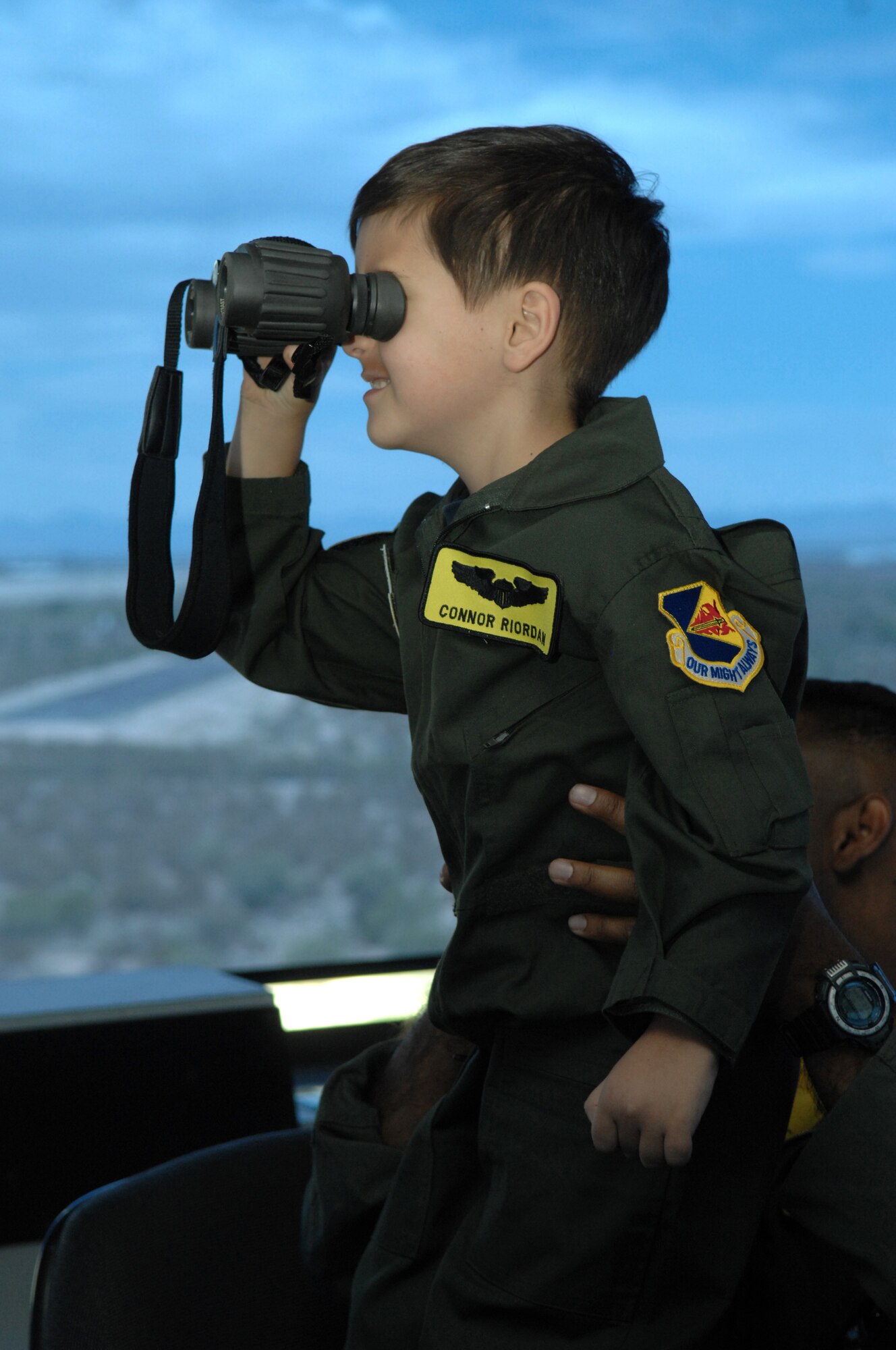 Connor Riordan, age 5, watches aircraft from the control tower here, May 9.  Connor participated in the Pilot for a Day program designed to give local children with illnesses an enjoyable day completely devoted to them and their interest in aviation. (U.S. Air Force photo/Airman 1st Class Noah R. Johnson)