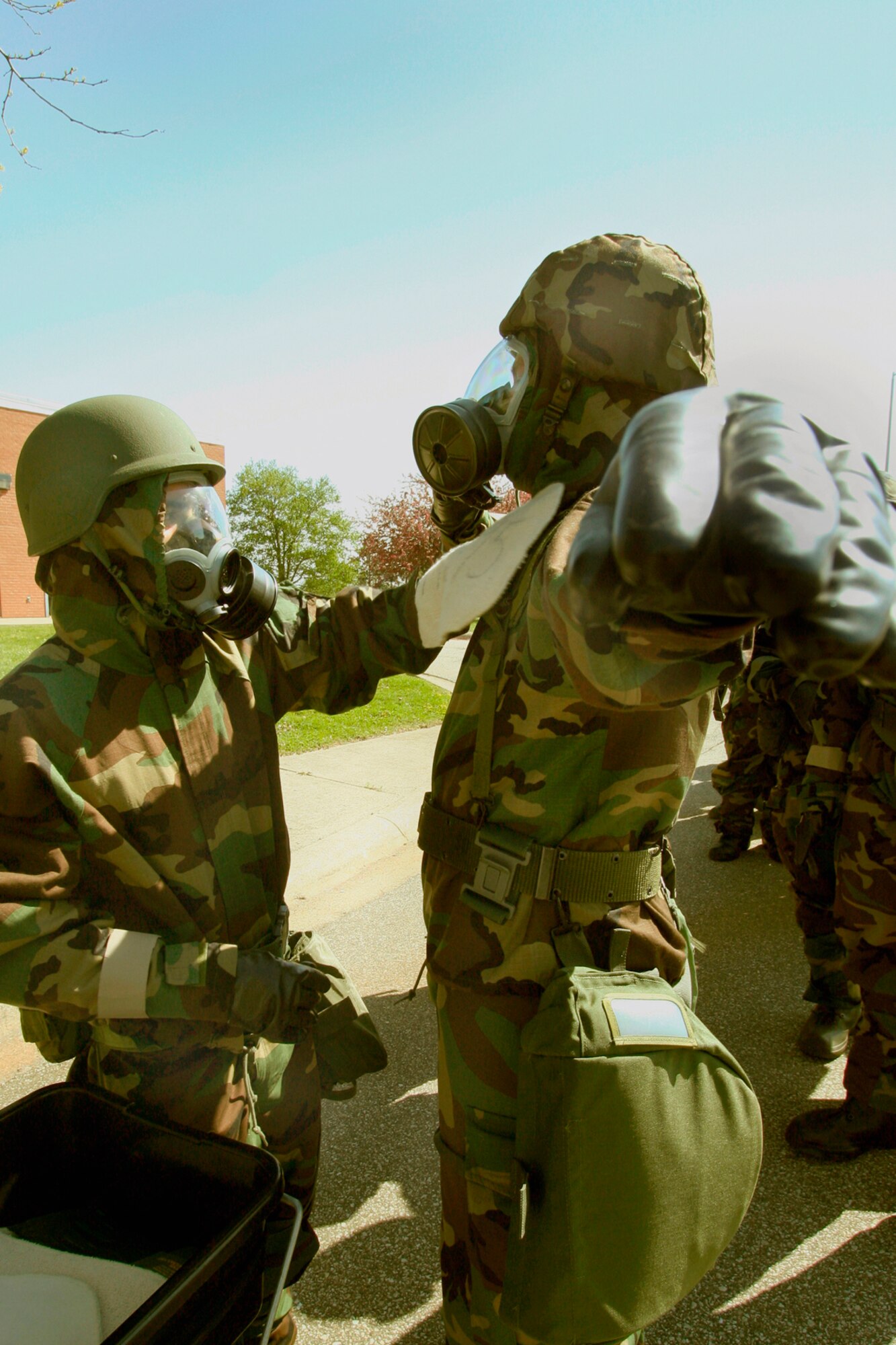 GRISSOM AIR RESERVE BASE, Ind., -- A member of the 434th Air Refueling Wing uses special gloves to help decontaminate a fellow Airman during a recent training exercise that simulated a chemical attack.  Grissom personnel participated in the exercise to enhance their ability to effectively work, and survive, in a chemical environment. (U.S. Air Force Photo/Tech. Sgt. Patrick Kuminecz)