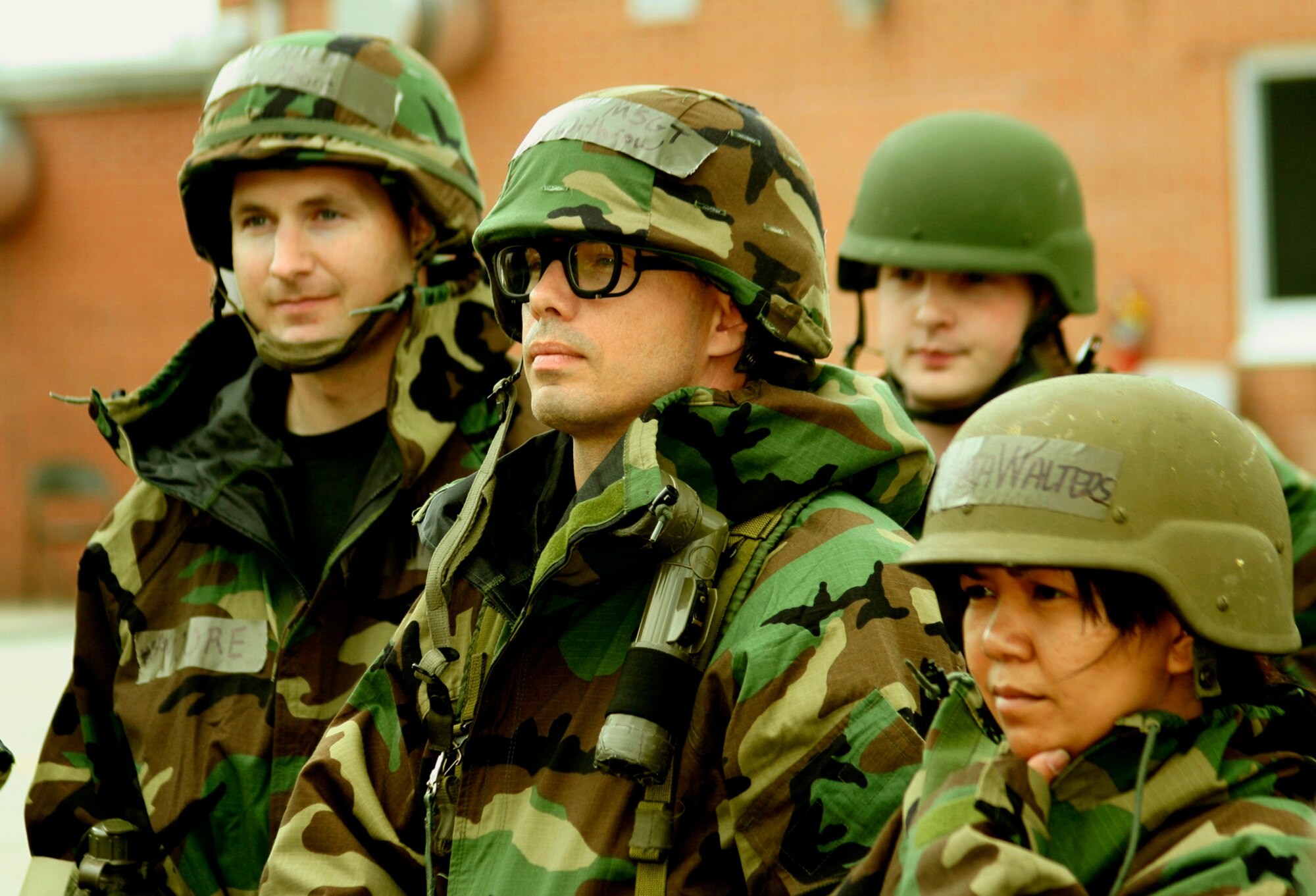 GRISSOM AIR RESERVE BASE, Ind.,-- Airmen from the 434th Air Refueling Wing listen closely to instruction given to them during a recent "Ability to Survive and Operate" training course.  A portion of the training dealt with the proper wear of chemical warfare suits and gas masks. ATSO training is just one of the many wartime skills taught to members of the 434th ARW during unit training assemblies. (U.S. Air Force Photo/Tech. Sgt. Patrick Kuminecz)