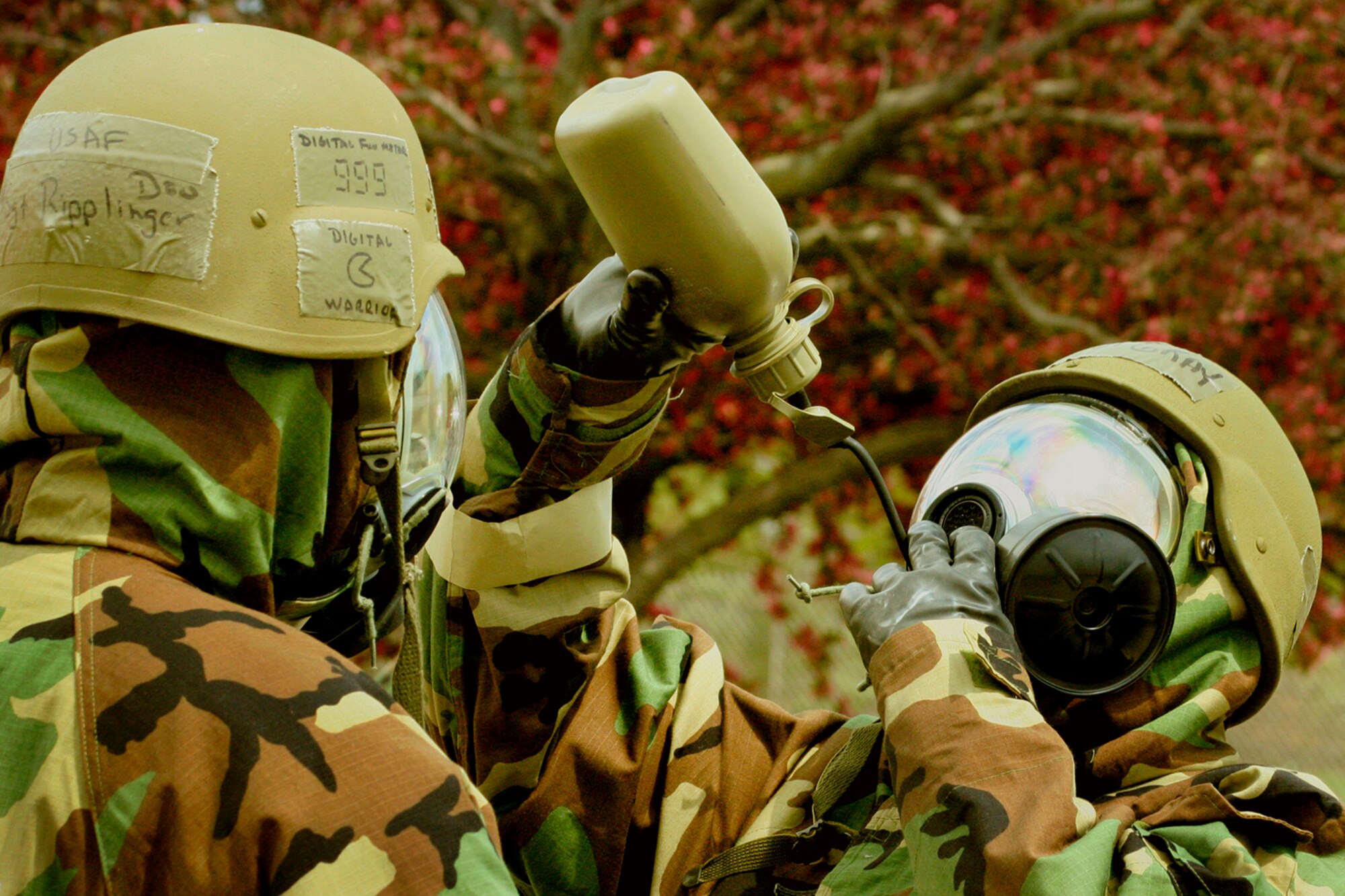 GRISSOM AIR RESERVE BASE, Ind., -- Master Sgt. Donald Ripplinger, 434th Communications Squadron, oversees an unidentified Airman getting a drink of water while in his chemical warfare suit.  A large number of base personnel participated in chemical, biological, radiation and nuclear, -- or CBRNE -- training during a recent unit training assembly to better prepare for an upcoming operational readiness inspection. (U.S. Air Force Photo/Tech. Sgt. Patrick Kuminecz)

