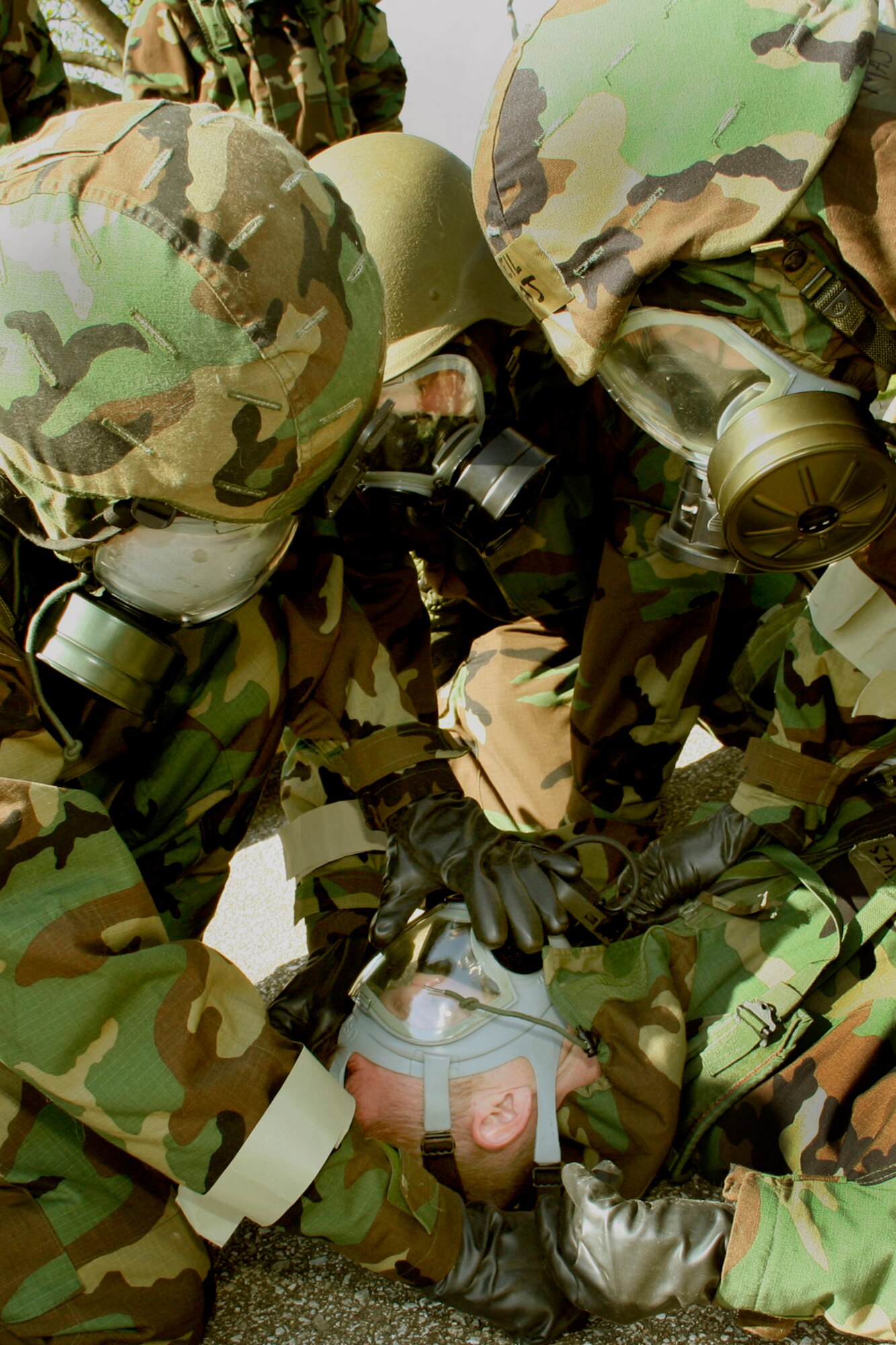 GRISSOM AIR RESERVE BASE, Ind., -- Base personnel participate in a simulated exercise where an Airman has been exposed to chemical weapons and are using the 'buddy system' to help treat a victim.  Chemical, biological, radiation and nuclear training, also know as CBRNE, was given to a large number of Grissom members during a recent unit training assembly.  (U.S. Air Force Photo/Tech. Sgt. Patrick Kuminecz)