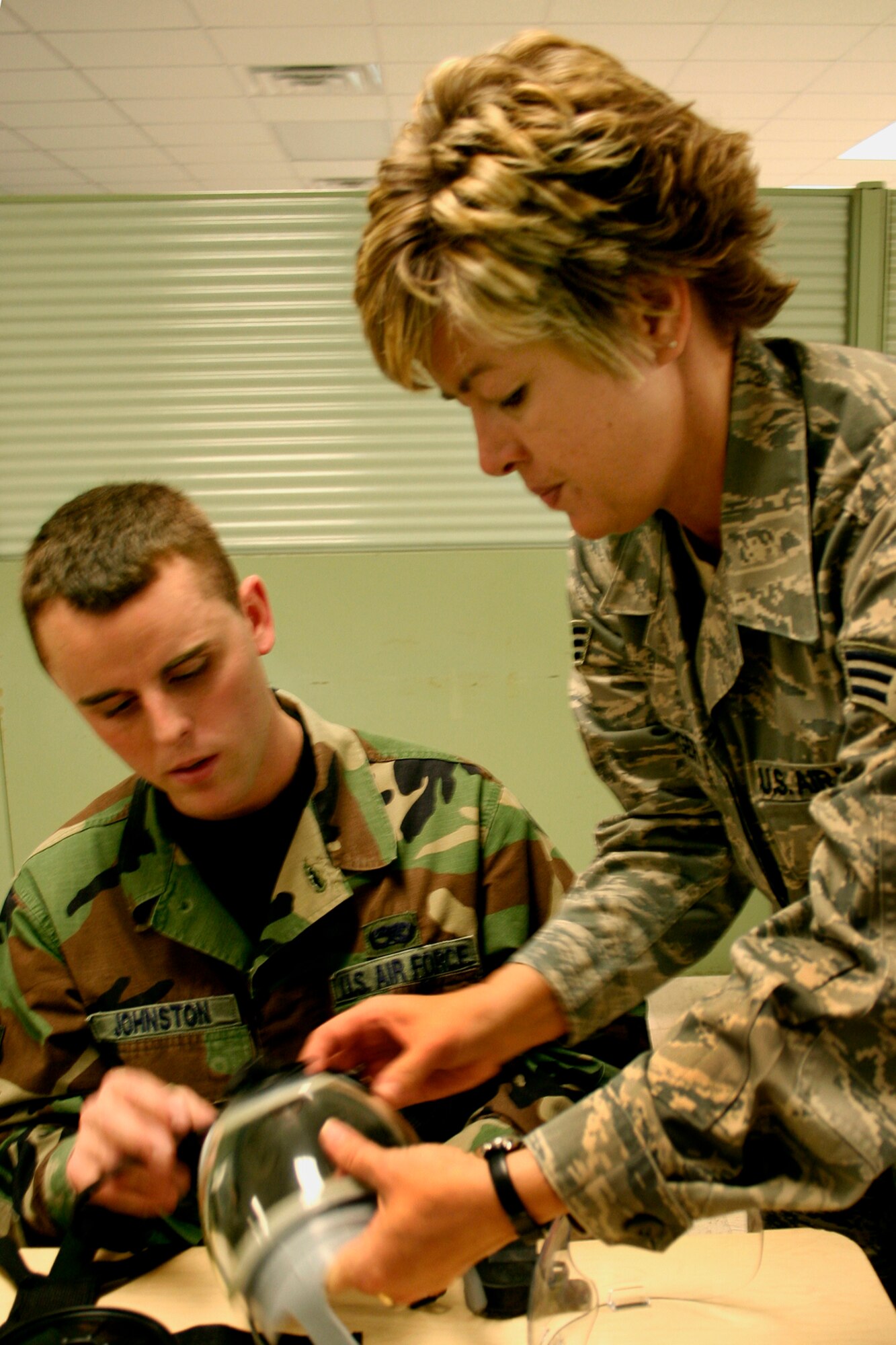 GRISSOM AIR RESERVE BASE, Ind., -- Senior Airman Robert Johnston, 434th Maintenance Squadron, is being instructed by Senior Airman Cathrine Shinabarger, emergency management readiness specialist, on the proper way to change out a filter canister on his gas mask.  Members of the 434th Air Refueling Wing participate in a variety of training activities and events each month.  (U.S. Air Force Photo/Tech. Sgt. Patrick Kuminecz)