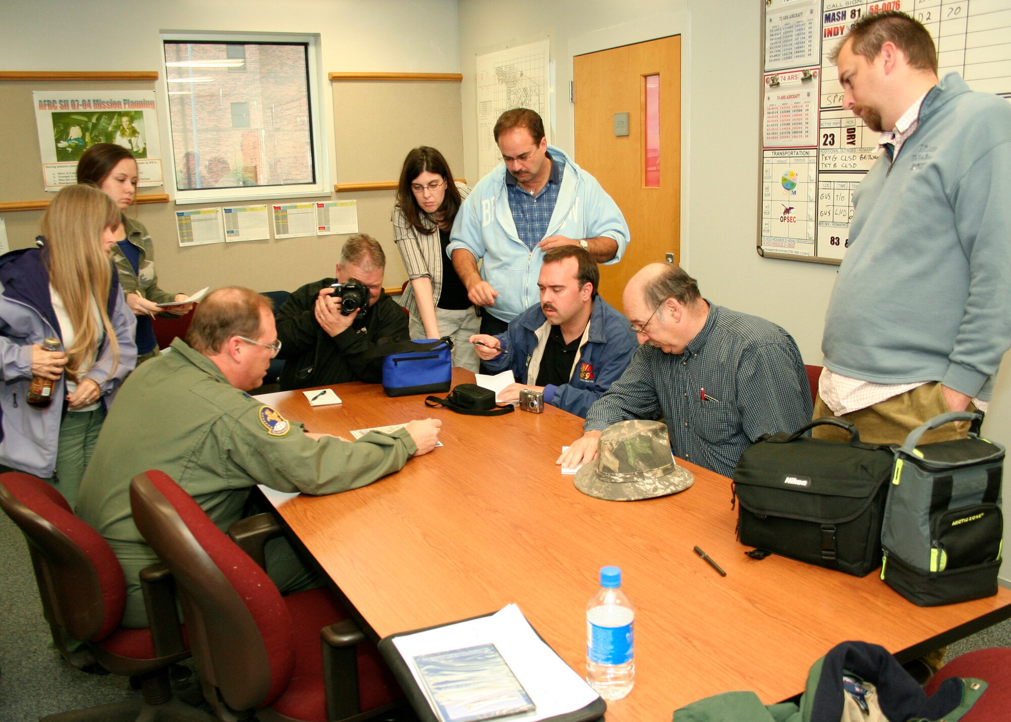GRISSOM AIR RESERVE BASE, Ind., -- Lt. Col. Dave Marien, a KC-135R pilot, briefs local media members on the mission in which they'll be participating. Members of the media had a recent opportunity to fly aboard a Grissom KC-135 Stratotanker and witness an aerial refueling mission with an E-3 Sentry aircraft from Tinker AFB, Okla. (U.S. Air Force photo/Tech. Sgt. Patrick Kuminecz)