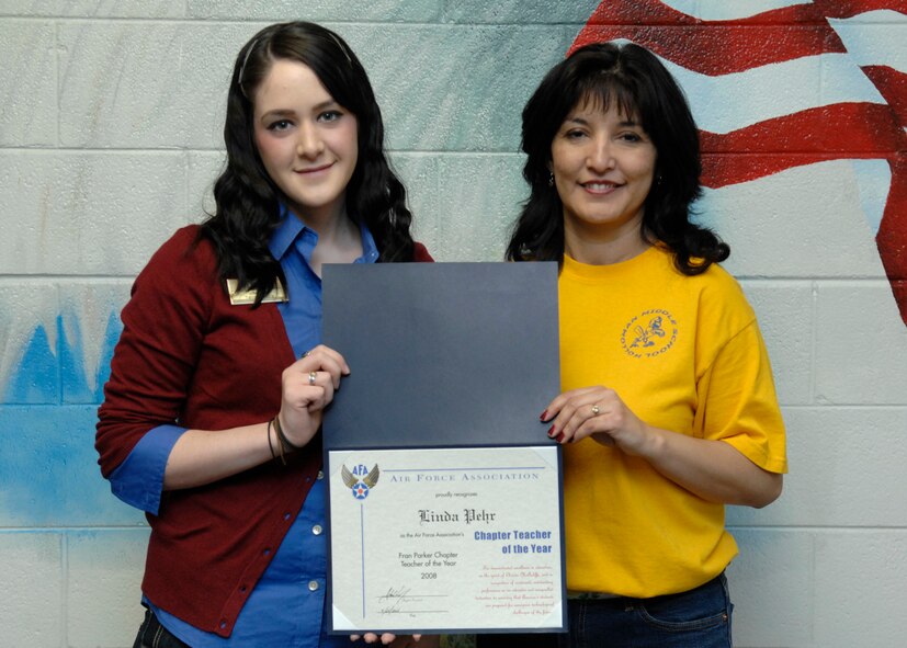 HOLLOMAN AIR FORCE BASE, N.M.-- Ms. Sydnee Vinson, Air Force Association chapter president, presents Chapter Teacher of the Year Award to Ms. Linda Pehr, Holloman Middle School math teacher, here May 2.  (U.S. Air Force photo/Airman 1st Class Rachel A. Kocin)