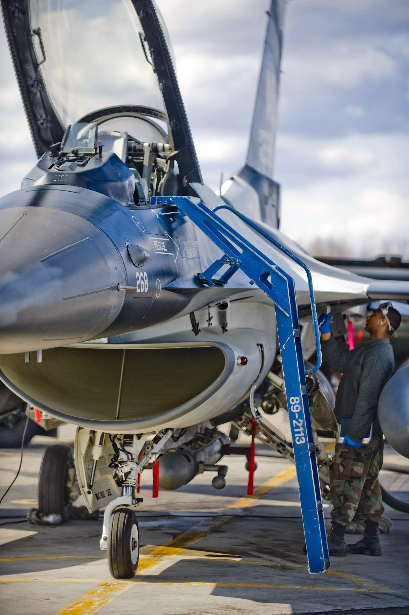 Airman 1st Class Kyle Hughes inspects an F-16 Fighting Falcom May 8 at Eielson Air Force Base, Alaska. The 18th Aggressor Squadron pilots are simulating enemy aircraft during Northern Edge, a joint-training exercise held yearly. Airman Hughes is a 354th Aircraft Maintenance Squadron crew chief. The exercise gives pilots a chance to train during a realistic representation of possible threats. (U.S. Air Force photo/Airman 1st Class Jonathan Steffen) 