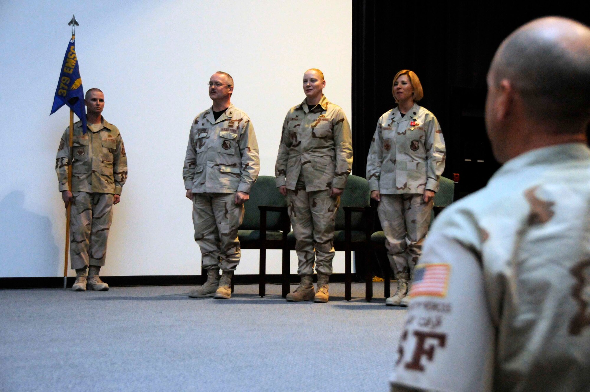 SOUTHWEST ASIA-- The official party stands for the 379th Expeditionary Force Support Squadron change of command and naming ceremony at the base theater May 11. The unit is now titled to reflect the Air Force-wide merger of the mission support and services squadrons. (U.S. Air Force photo/ Senior Airman Domonique Simmons)