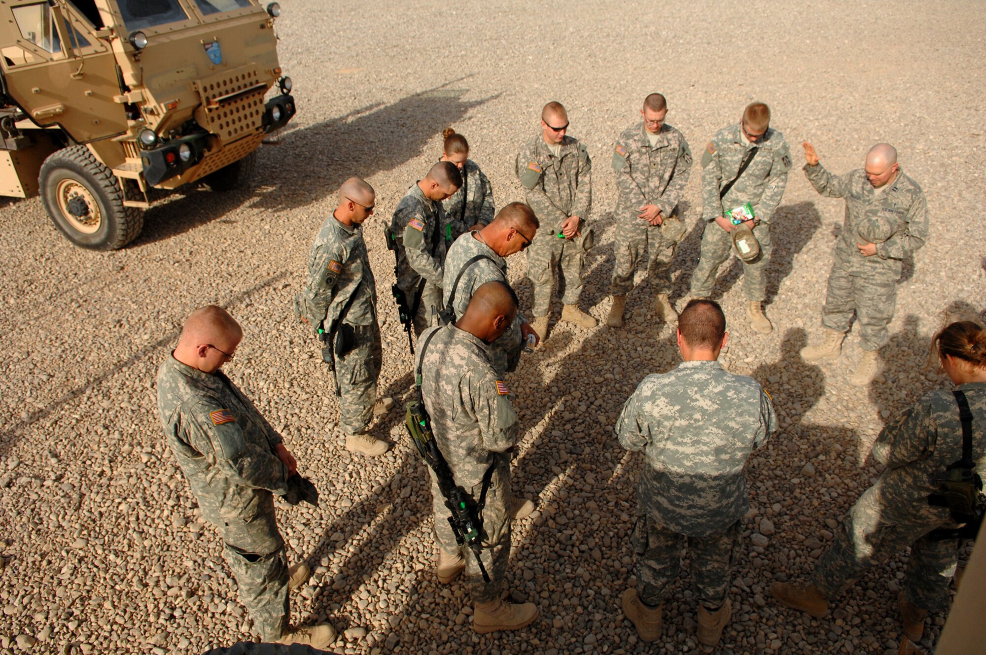 BALAD AIR BASE, Iraq -- Air Force Chaplain (Capt.) Jeffrey Granger, 332nd Air Expeditionary Wing, prays for the safety of a group of Soldiers from the 16th of the 38th Truck Company about to embark on a convoy mission, May 12. Chaplains provide various religious services and materials to deployed personnel to fulfill their spiritual needs; chaplains can also help bolster morale among servicemembers. Captain Granger is deployed from Ellsworth Air Force Base, S.D. (U.S. Air Force photo/ Senior Airman Julianne Showalter)