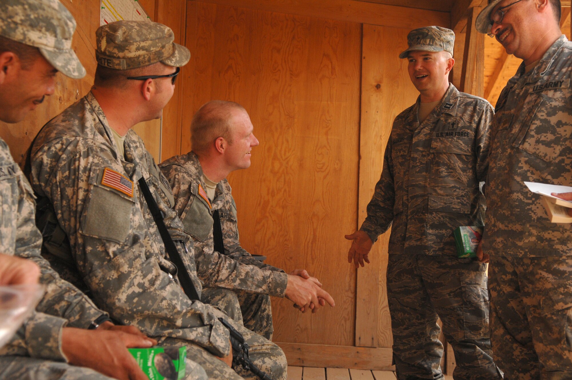 BALAD AIR BASE, Iraq -- (From right) Army Chaplain (Maj.) Carlos Carrea, 55th Sustainment Brigade, and Air Force Chaplain (Capt.) Jeffrey Granger, 332nd Air Expeditionary Wing, speak with Soldiers from the 16th of the 38th Truck Company about an upcoming convoy mission here, May 12. Chaplains provide various religious services and materials to deployed personnel to fulfill their spiritual needs; chaplains can also help bolster morale among servicemembers. During their visit with the Soldiers about to convoy, the chaplains handed out boxes of Girl Scout cookies to remind them of the comforts of home while on the road. Girl Scouts from Eastern Massachusetts recently donated 1,500 boxes of cookies to the Balad AB. Major Carrea is deployed from Fort Buchanan, Puerto Rico; Captain Granger is deployed from Ellsworth Air Force Base, S.D. (U.S. Air Force photo/ Senior Airman Julianne Showalter)