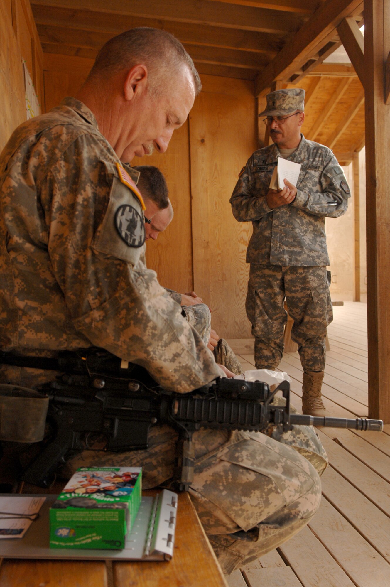 BALAD AIR BASE, Iraq -- Army Chaplain (Maj.) Carlos Carrea, 55th Sustainment Brigade chaplain, prays for the safety of a group of Soldiers from the 16th of the 38th Truck Company about to leave on a convoy from here, May 12. Chaplain Carrea and Air Force Chaplain (Capt.) Jeffrey Granger, 332nd Air Expeditionary Wing chaplain, visited with the group and gave them boxes of Girl Scout cookies to take with them on their journey; the cookies were donated from Girl Scouts in Eastern Massachusetts. Chaplains provide various religious services and materials to deployed personnel to fulfill their spiritual needs; chaplains can also help bolster morale among servicemembers. Major Carrea is deployed from Fort Buchanan, Puerto Rico; Captain Granger is deployed from Ellsworth Air Force Base, S.D. (U.S. Air Force photo/ Senior Airman Julianne Showalter)