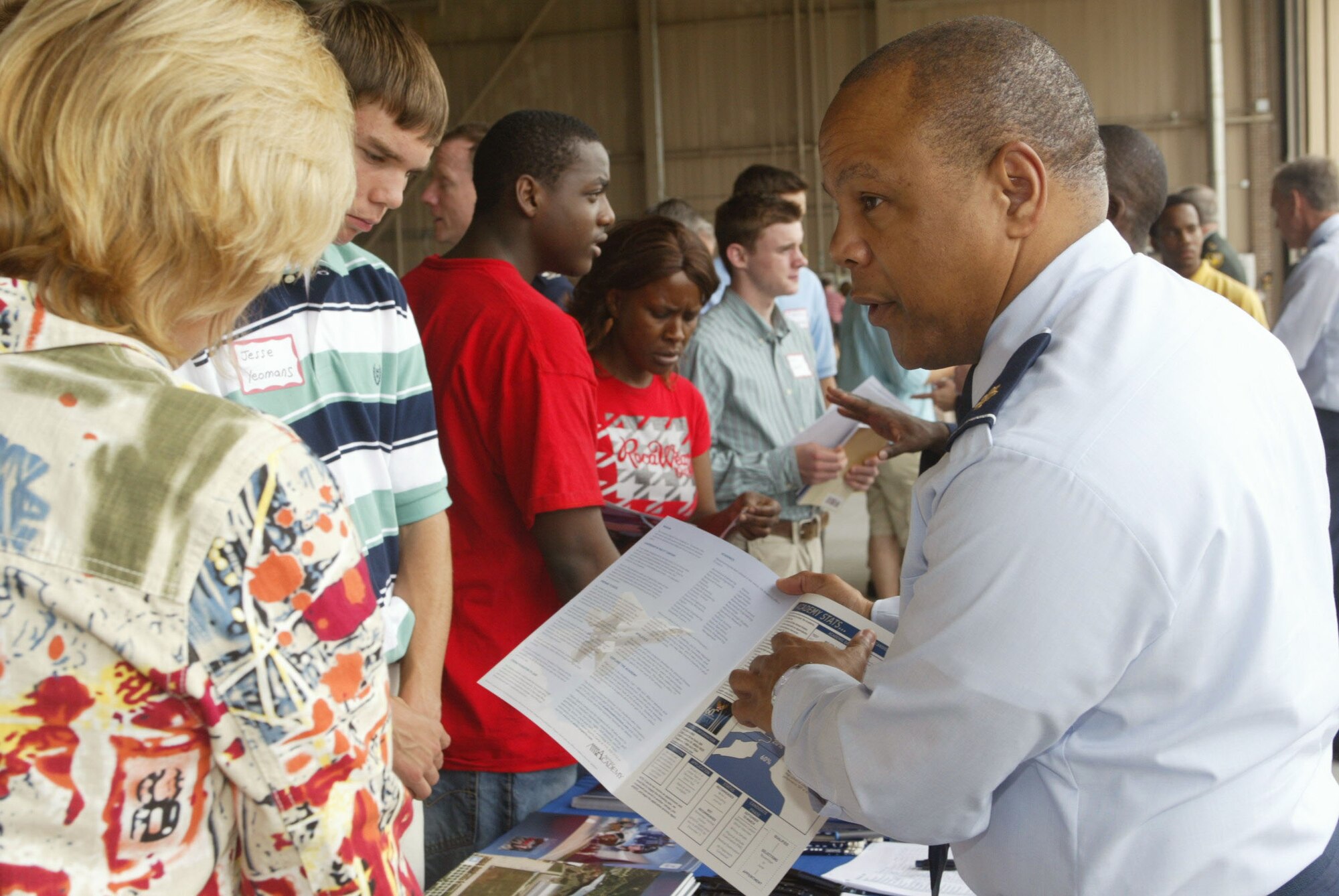 DOBBINS AIR RESERVE BASE, Ga., -- Maj. Brian "Derek" Collins, an admissions liason officer for the U.S. Air Force Academy and ROTC programs explains details about the Air Force Academy to an interested student and parent attending Academy Day at Dobbins ARB May 10, 2008. Academy Day is a chance for prospective students to learn more about the services and interact with congressional members and staffers. More than 600 Atlanta area students attended. (U.S. Air Force photo/Don Peek)