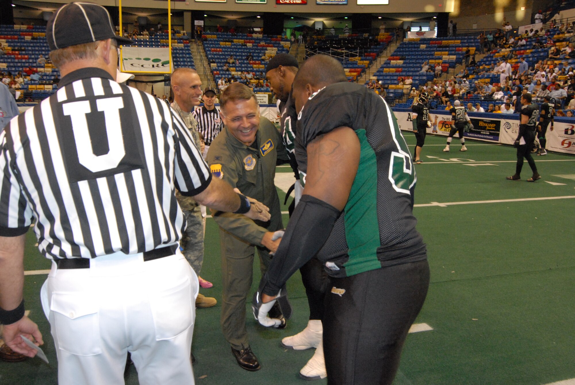 Col. John McDonald, 43rd Airlift Wing Commander, shakes hands with Fayetteville Guard lineman Garry Battle prior to the Guard's Operation Welcome Home game against the Augusta Colts May 10. (U.S. Air Force Photo by 2nd Lt. Chris Hoyler)