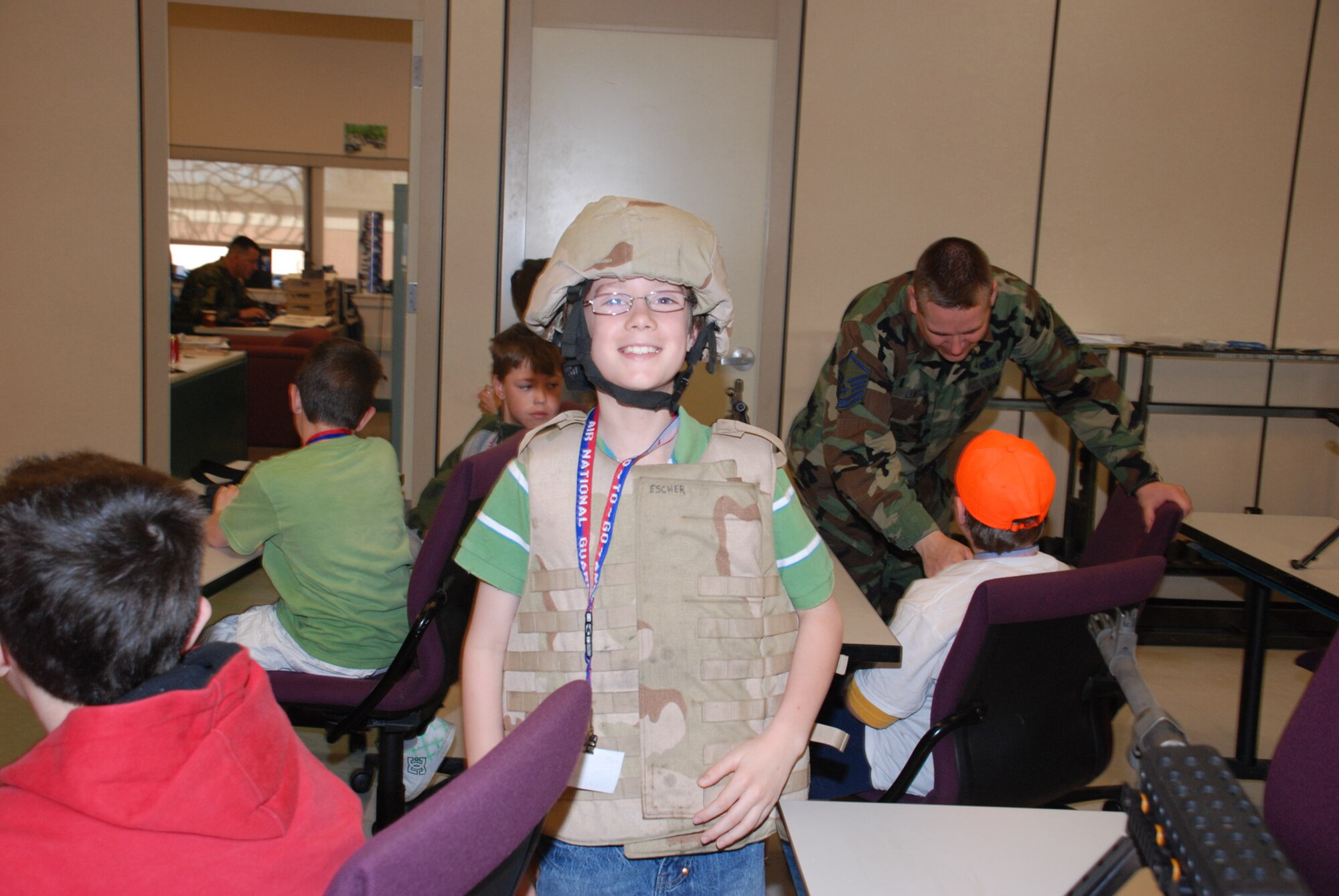 9-year-old Brenden Talarczyk, son of a 107th Airlift Wing member, tries on a flak vest and a Kevlar helmet during the 107th?s bring your kids to work day event on April 24.  