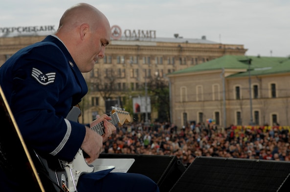 Staff Sgt. Jason Cale, U.S. Air Forces in Europe jazz band (Check Six), plays his guitar solo during the song 'Boogie Woogie' , Svobody Square located in Kharkiv, Ukraine, April 19. The USAFE Band has been entertaining military and civilian audiences throughout Europe, Southwest Asia and Africa for the past 60 years.  (U.S. Air Force photo by Airman 1st Class Amber Bressler)(Released)