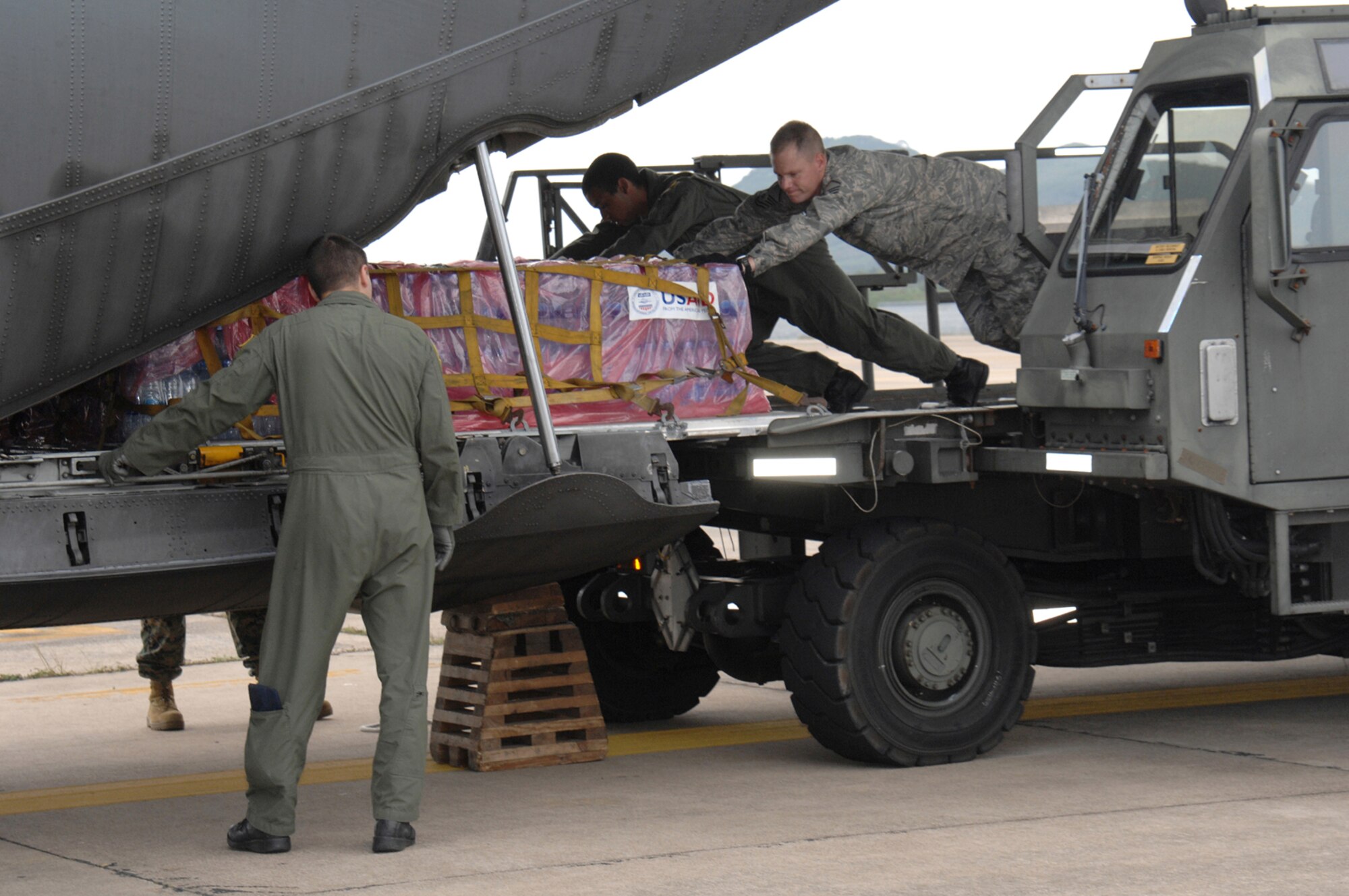 UTAPAO, Thailand - Master Sgt. Todd Kneisly, 36th Mission Response Squadron, and Airman 1st Class Robert Gore, 36th Airlift Squadron, Yokota Air Base, Japan, load a C-130 Hercules with humanitarian relief supplies for victims of Burma who experienced one of the regions deadliest cyclones, Cyclone Nargis.  As of May 12, 2008 a total of more than $3 million in USAID, and humanitarian assistances has been provided to Burma since the catastrophic destruction on May 2. (USAF Photo/Senior Airman Sonya Croston)