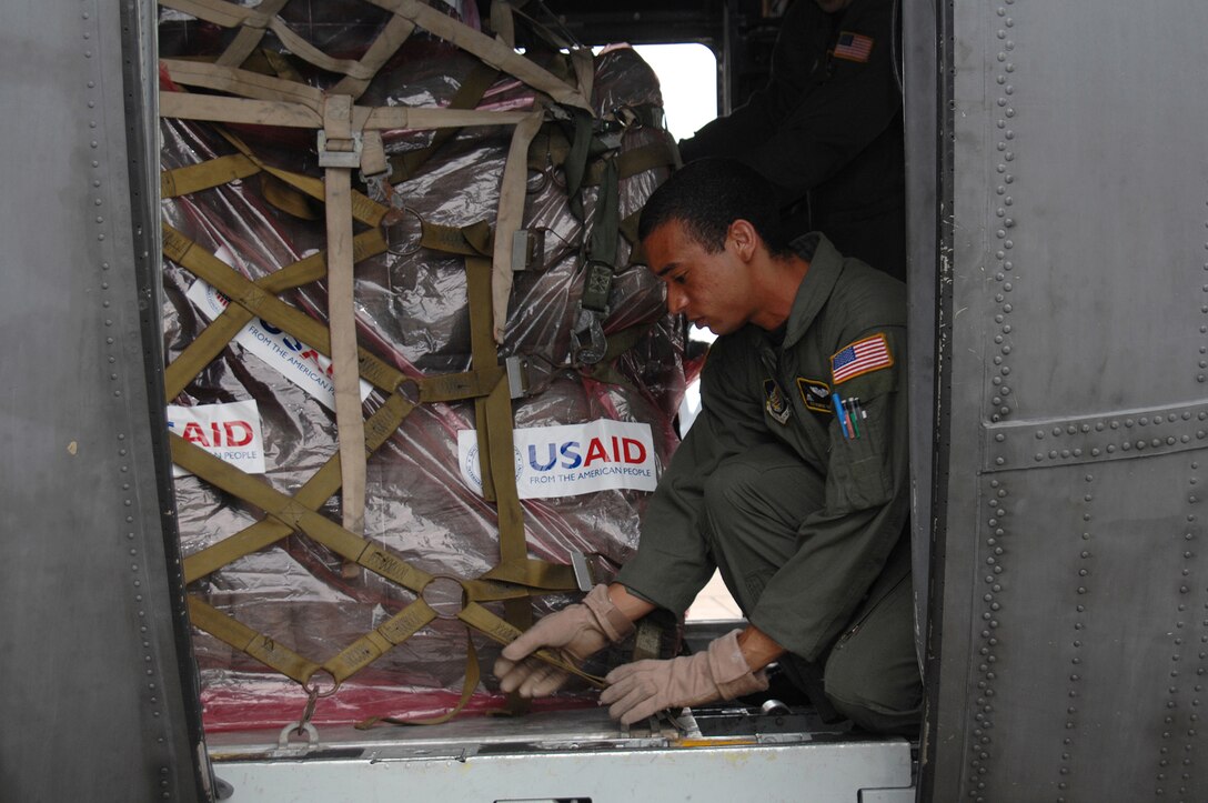 UTAPAO, Thailand - Airman 1st Class Robert Gore, 36th Airlift Squadron, Yokota Air Base, Japan, tightens cargo straps from a pallet loaded with blankets for delivery to victims of Cyclone Nargis in Burma. Servicemembers from various locations throughout the Pacific dedicated their time and effort to support those in need when called upon. (USAF Photo/Senior Airman Sonya Croston)