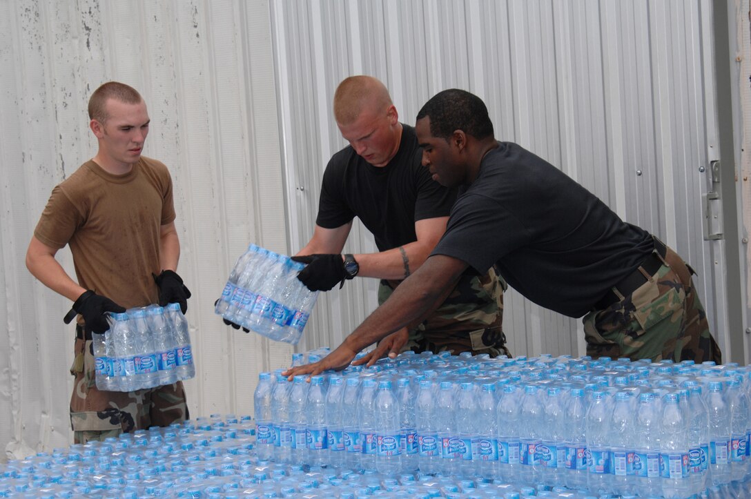 UTAPAO, Thailand - Senior Airman Shaun Rhine, Staff Sgt. Shaun Kegin and Tech. Sgt. Andree Curlee, 36th Contingency Response Group, prepare the package and delivery of bottled water in support of humanitarian relief efforts for the victims of Cyclone Nargis in Burma. Approximately 45 military personnel from Andersen AFB arrived in Thailand on May 8 to offer their assistance with a water purification unit and two airfield opening/operating teams. (USAF Photo/Senior Airman Sonya Croston)