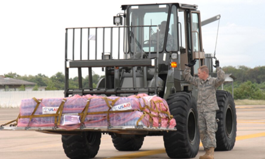 UTAPAO, Thailand - Master Sgts. Todd Kneisly and Don Gambles, 36th Mission Response Squadron, transport a pallet of bottled water weighing in at approximately 4000 lbs to a C-130 Hercules for humanitarian relief to victims of Burma May 12. About 45 well trained and highly motivated members from Andersen AFB arrived in Thailand on 8 May prepared to provide a water purification unit and two airfield opening/operating systems. (USAF Photo/Senior Airman Sonya Croston)