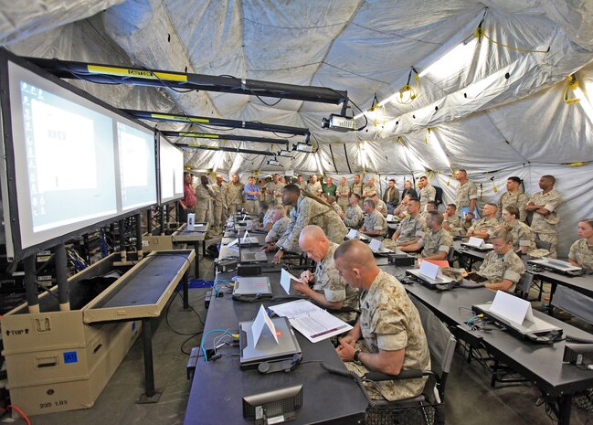 Marines from II Marine Expeditionary Force fill the combat operations center during a field exercise aboard Marine Corps Base Camp Lejeune, N.C. The MCSC COC team won team 2013 Secretary of Defense Performance-Based Logistics System Level Award by keeping sustainment costs low and availability high using a performance-based logistics, the Department of Defense's preferred product support strategy.