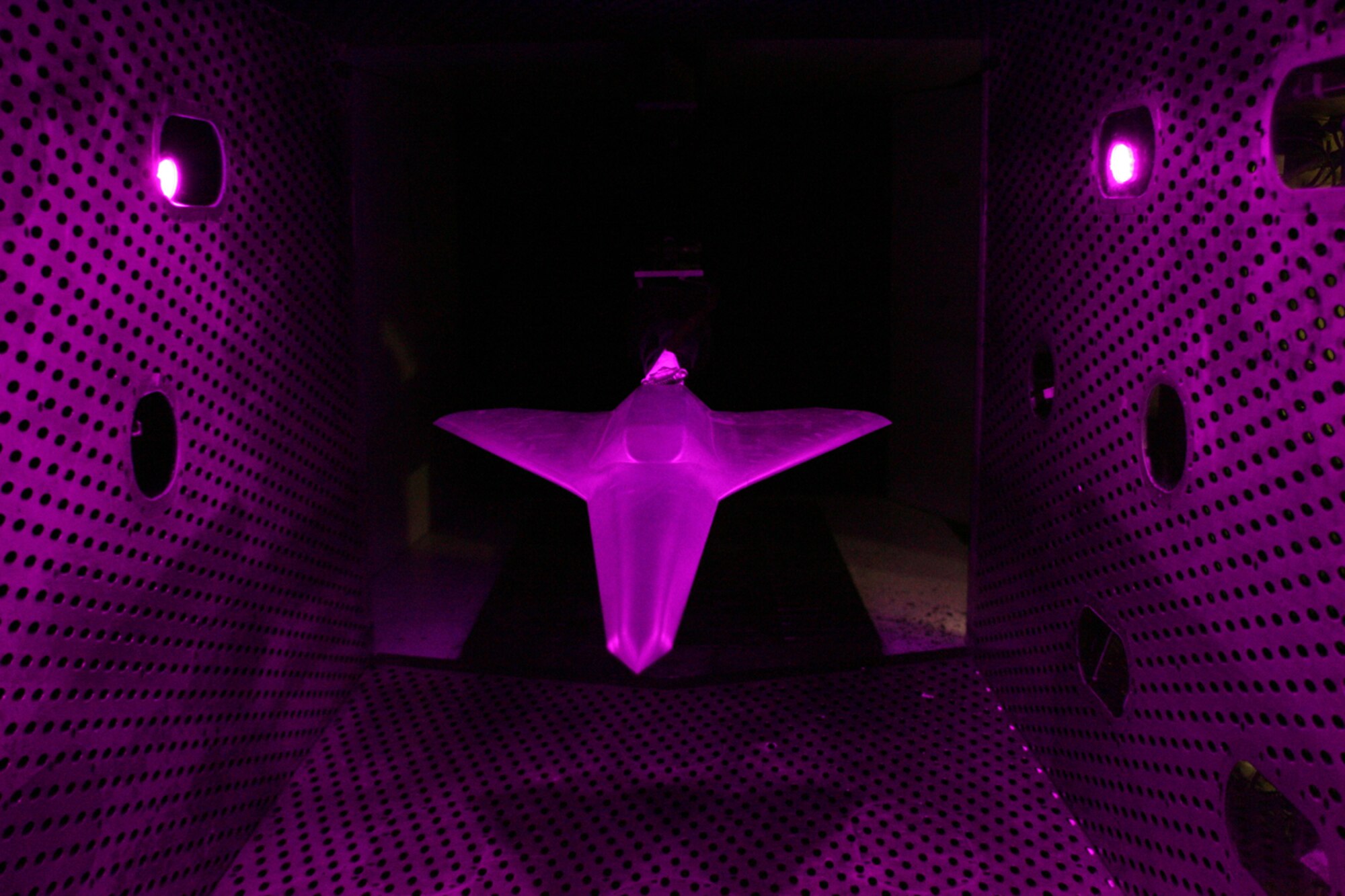 A one-eighteenth scale model of an Air Force tailless aircraft recently underwent aerodynamic testing in Arnold Engineering Development Center’s four-foot transonic wind tunnel. The test was a technology demonstration entry in which conventional methods and Pressure Sensitive Paint were used to compare the effectiveness of a jet effects spoiler with a solid spoiler in yaw and roll control and stability of the aircraft. (Photos by Rick Goodfriend)