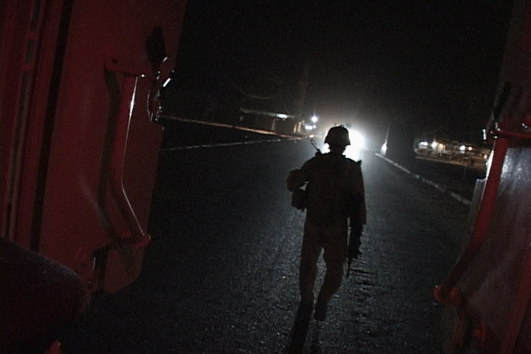 Sgt. Dennis K. Derr II, a mobile assault platoon section leader, dismounts a vehicle to begin a night patrol. Derr and his section of Marines operate well away from higher command camped near the city of Fallujah. The tight-knit group patrols through Amariyah, Ferris Town and surrounding areas, working with Iraqi police and provincial security forces to halt terrorist activity. The platoon is attached to Weapons Company, 3rd Battalion, 6th Marine Regiment, Regimental Combat Team 1.