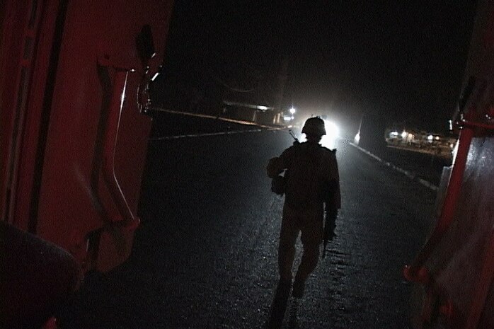 Sgt. Dennis K. Derr II, a mobile assault platoon section leader, dismounts a vehicle to begin a night patrol. Derr and his section of Marines operate well away from higher command camped near the city of Fallujah. The tight-knit group patrols through Amariyah, Ferris Town and surrounding areas, working with Iraqi police and provincial security forces to halt terrorist activity. The platoon is attached to Weapons Company, 3rd Battalion, 6th Marine Regiment, Regimental Combat Team 1.