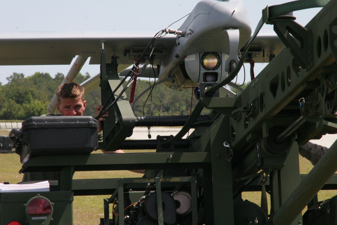 Cpl. Phillip Buttiens, an unmanned aerial vehicle mechanic with VMU-2, performs preflight checks on the RQ-7B Shadow.