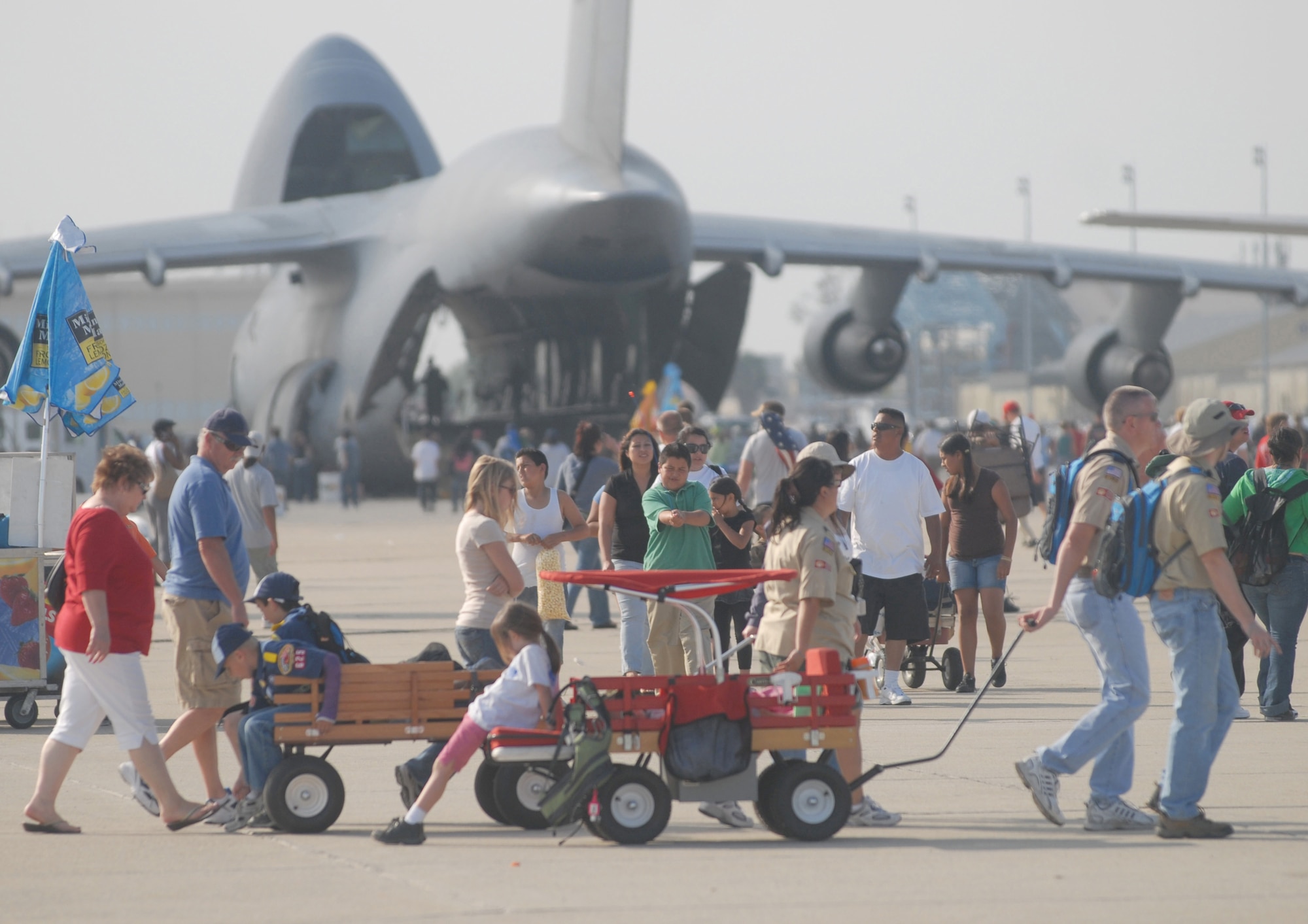The crowd enjoys the aircraft static display and aerial demonstrations during AirFest '08 on the flight line at March Air Reserve Base, Calif.. The May 3-4 air show, called "Thunder Over the Empire," attracted about 400,000 visitors to the base. It coincides with the 90th anniversary of March as a military base and the 60th anniversary of the Air Force Reserve. (U.S. Air Force photo by Val  Gempis) 