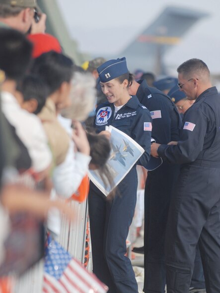 Capt. Elizabeth Kreft, Thunderbirds' public affairs officer, sign autographs during AirFest '08 at March Air Reserve Base, Calif., May 4, 2008. The May 3-4 air show, called "Thunder Over the Empire," attracted about 400,000 visitors to the base. It coincides with the 90th anniversary of March as a military base and the 60th anniversary of the Air Force Reserve.(U.S. Air Force photo by Val  Gempis)