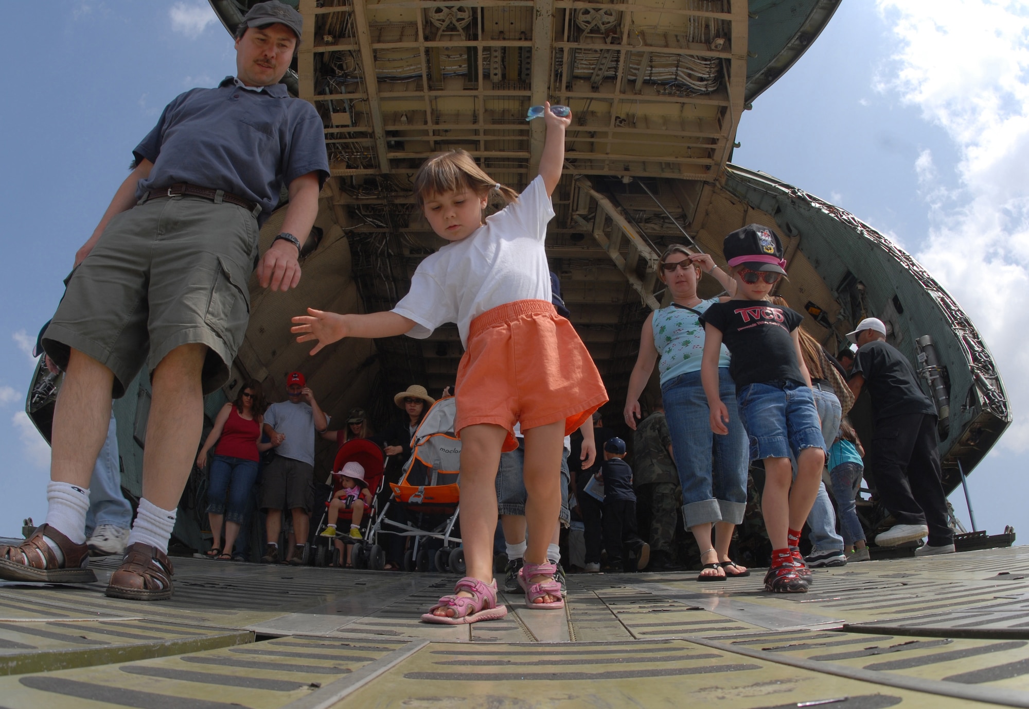 A young girl carefully walks down the cargo ramp of an Air Force C-5 Galaxy cargo aircraft, from the 433rd Airlft Wing, Lackland Air Force Base, Texas, during AirFest '08 at March Air Reserve Base, Calif. The May 3-4 air show, called "Thunder Over the Empire," attracted about 400,000 visitors to the base. It coincides with the 90th anniversary of March as a military base and the 60th anniversary of the Air Force Reserve. (U.S. Air Force photo by Val  Gempis) 
